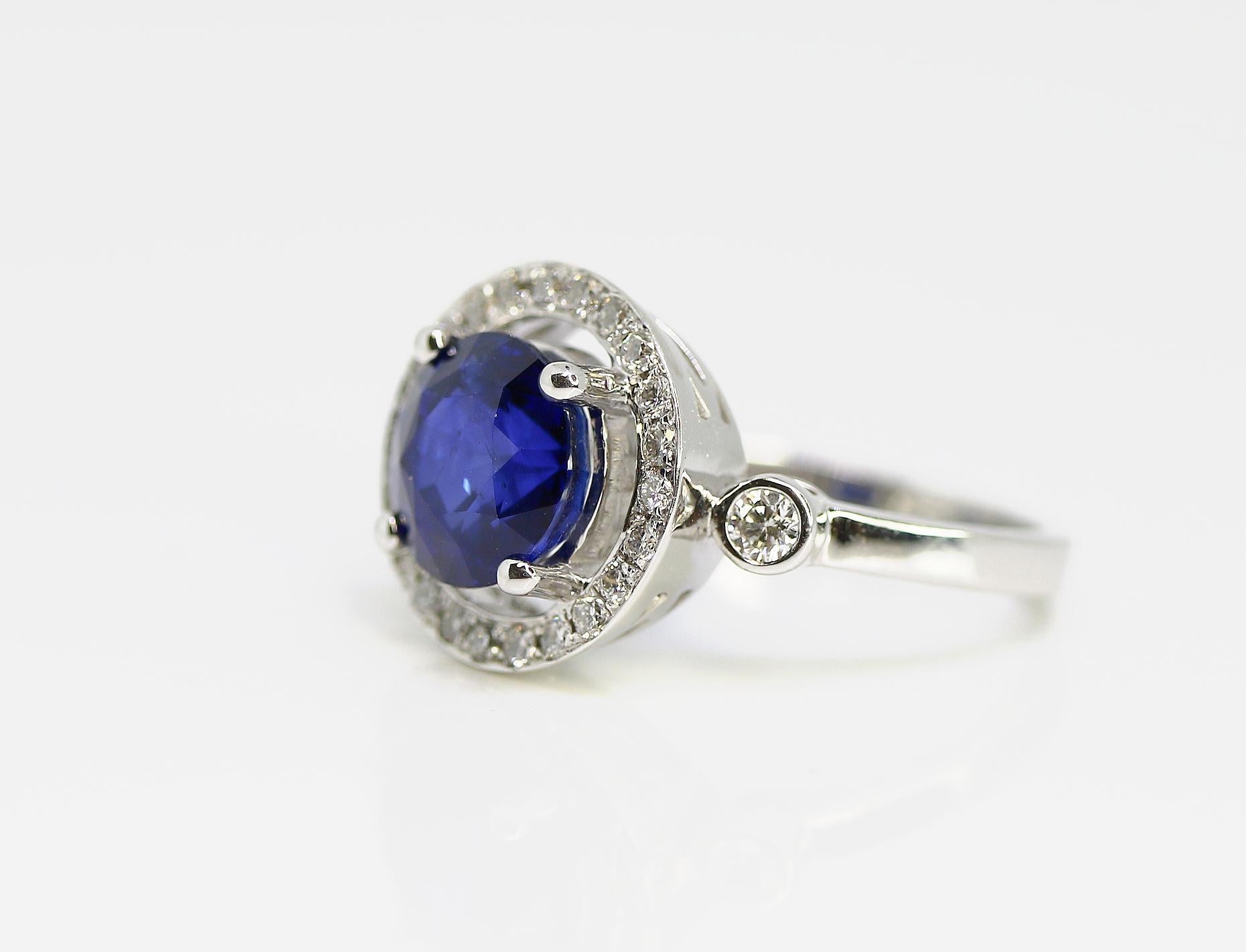 This 3.17ct blue Sapphire set in 18K white gold ring with a specially designed round Halo with colorless diamonds =0.38cttw