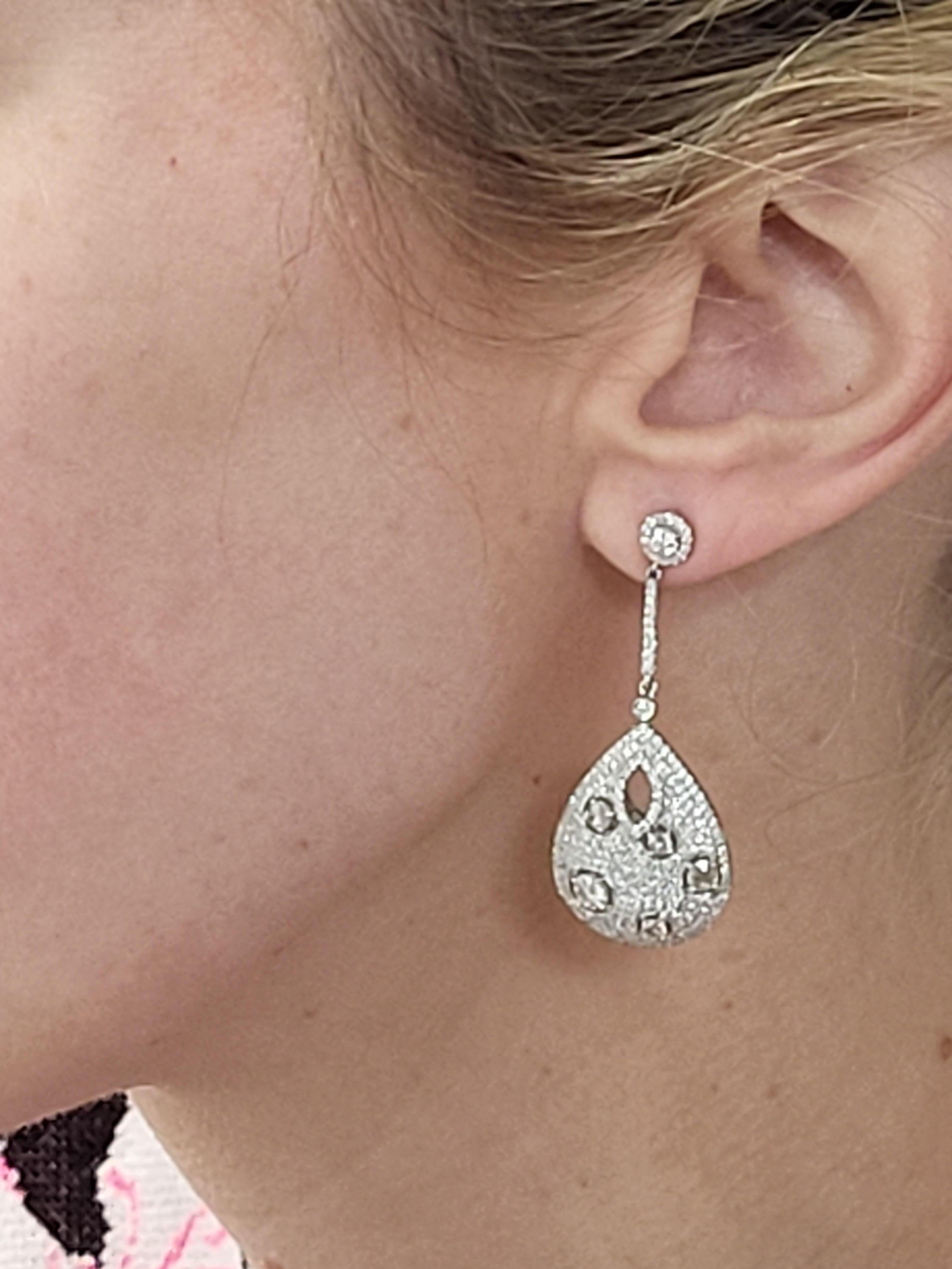 This unique dangle earrings feature 3.17 carat total weight in micro pave set diamonds & prong-set round brilliant and rose cut diamonds set in 18 karat white gold. Friction post with jumbo back. 
Measurements: Approximately 1.75