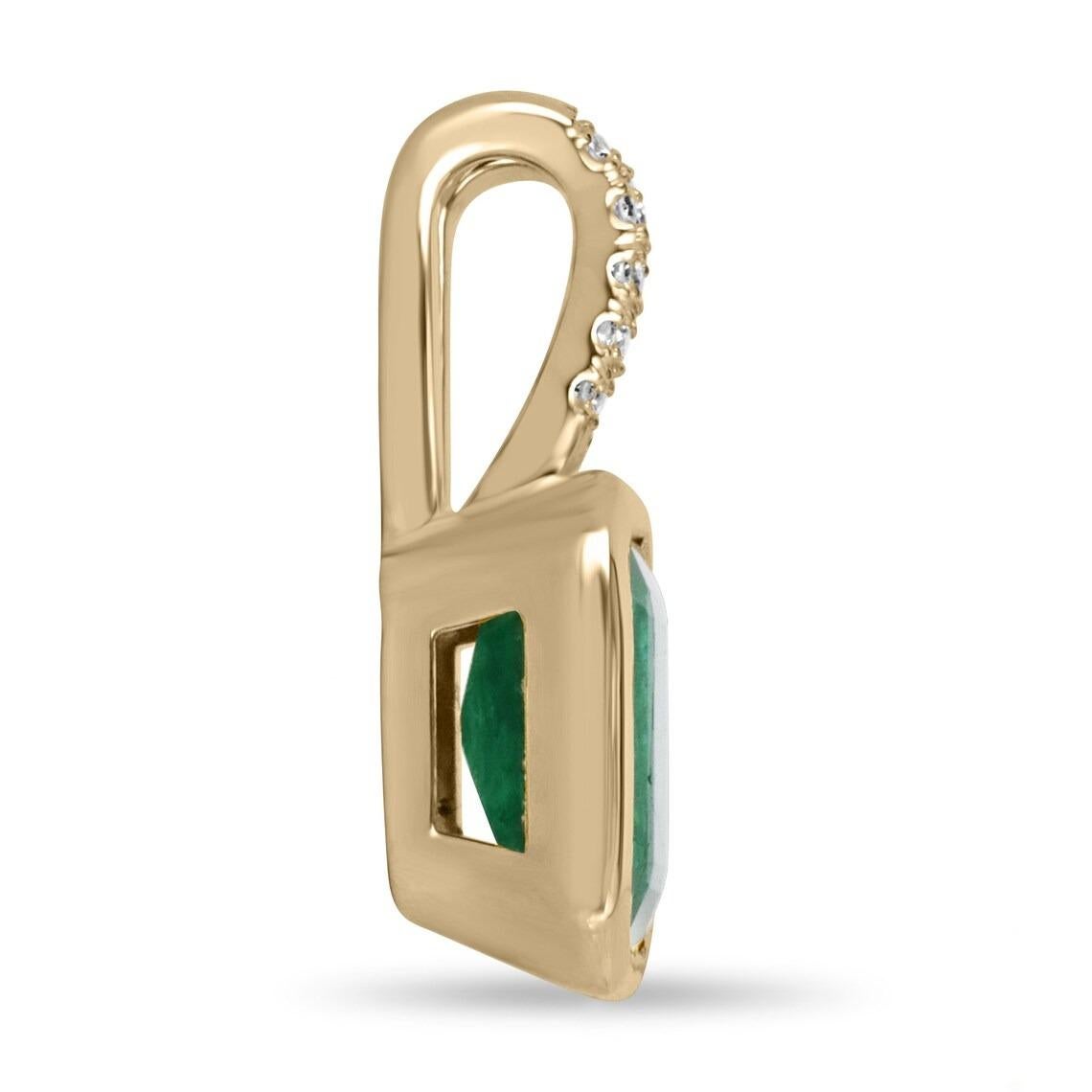 A ravishing bezel set emerald and diamond accent pendant. The center of attention consists of 3.12-carats of pure emerald goodness. The gemstone displays a remarkable vivid forest dark green color, with very good clarity and luster. Surface-reaching