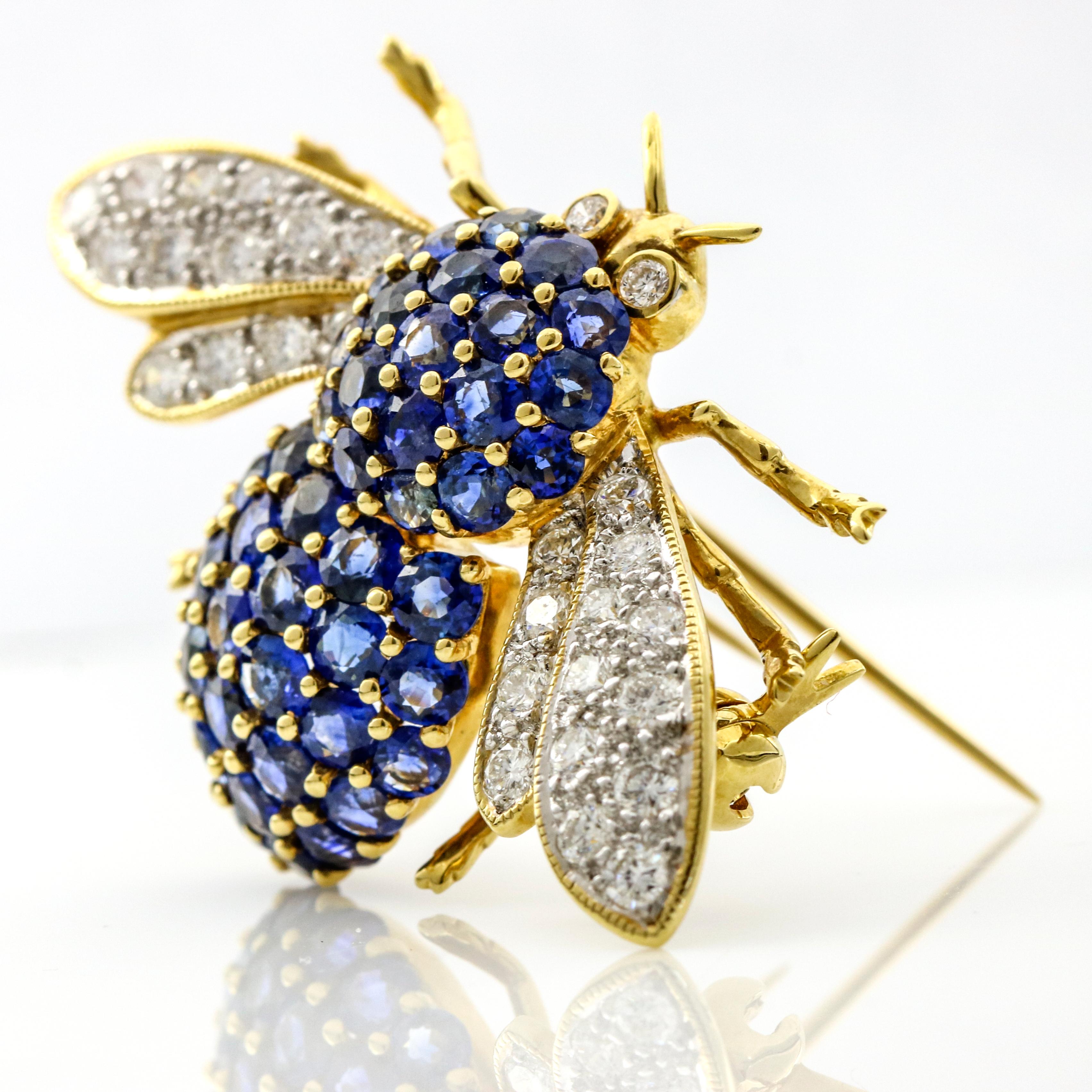 Bee brooch in 18-karat yellow gold with blue sapphires and diamonds. The bee body is prong-set with 46 round-cut natural sapphires, the wings are pave set with numerous near colorless diamonds and the eyes are accented with 2 bezel set round