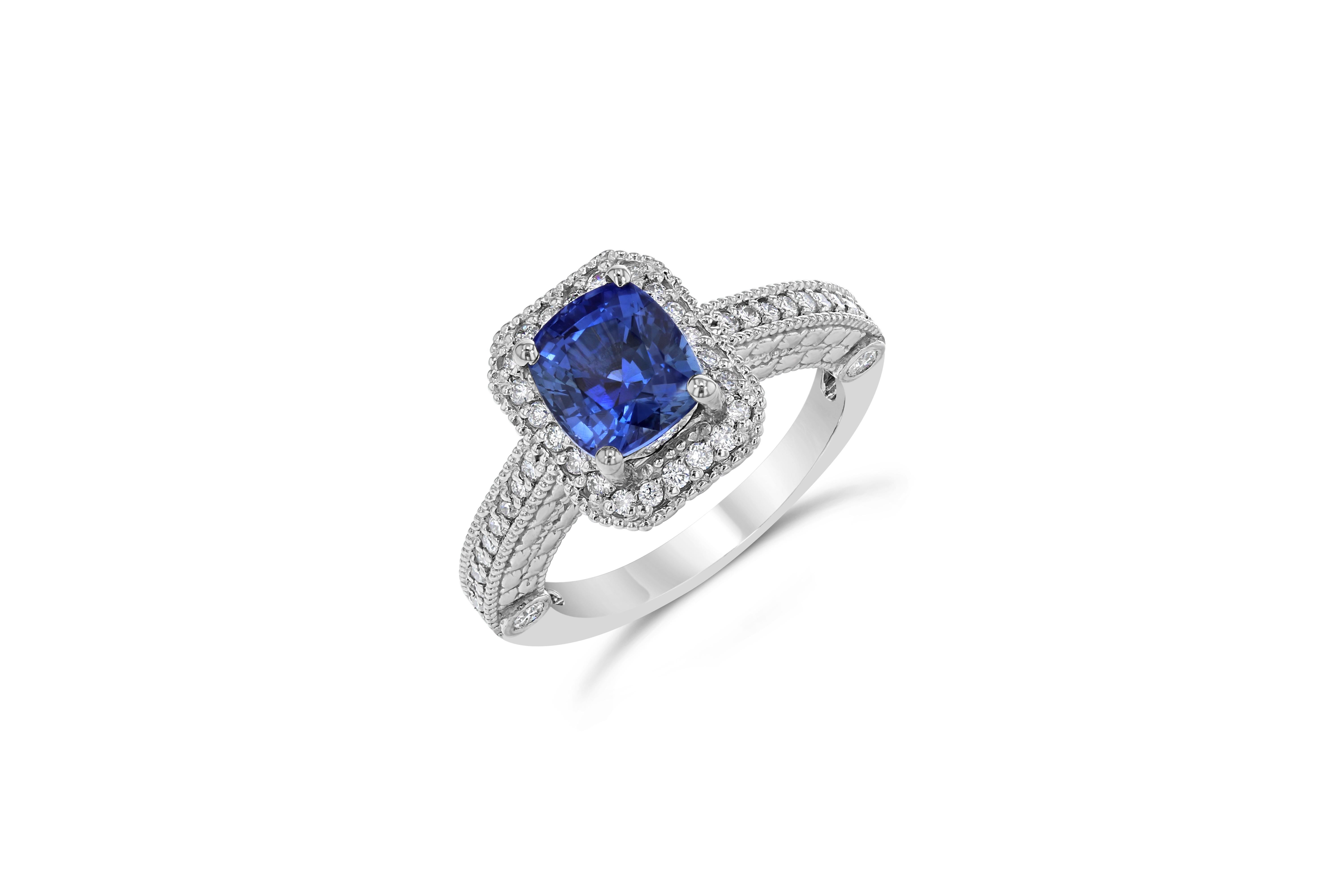 Stunning alternative to a regular diamond engagement ring! 

This blazing blue sapphire ring has a Cushion Cut 2.65 Carat Blue Sapphire and is surrounded by a pave halo of 46 Round Cut Diamonds that weigh 0.53 Carats. The clarity and color of the