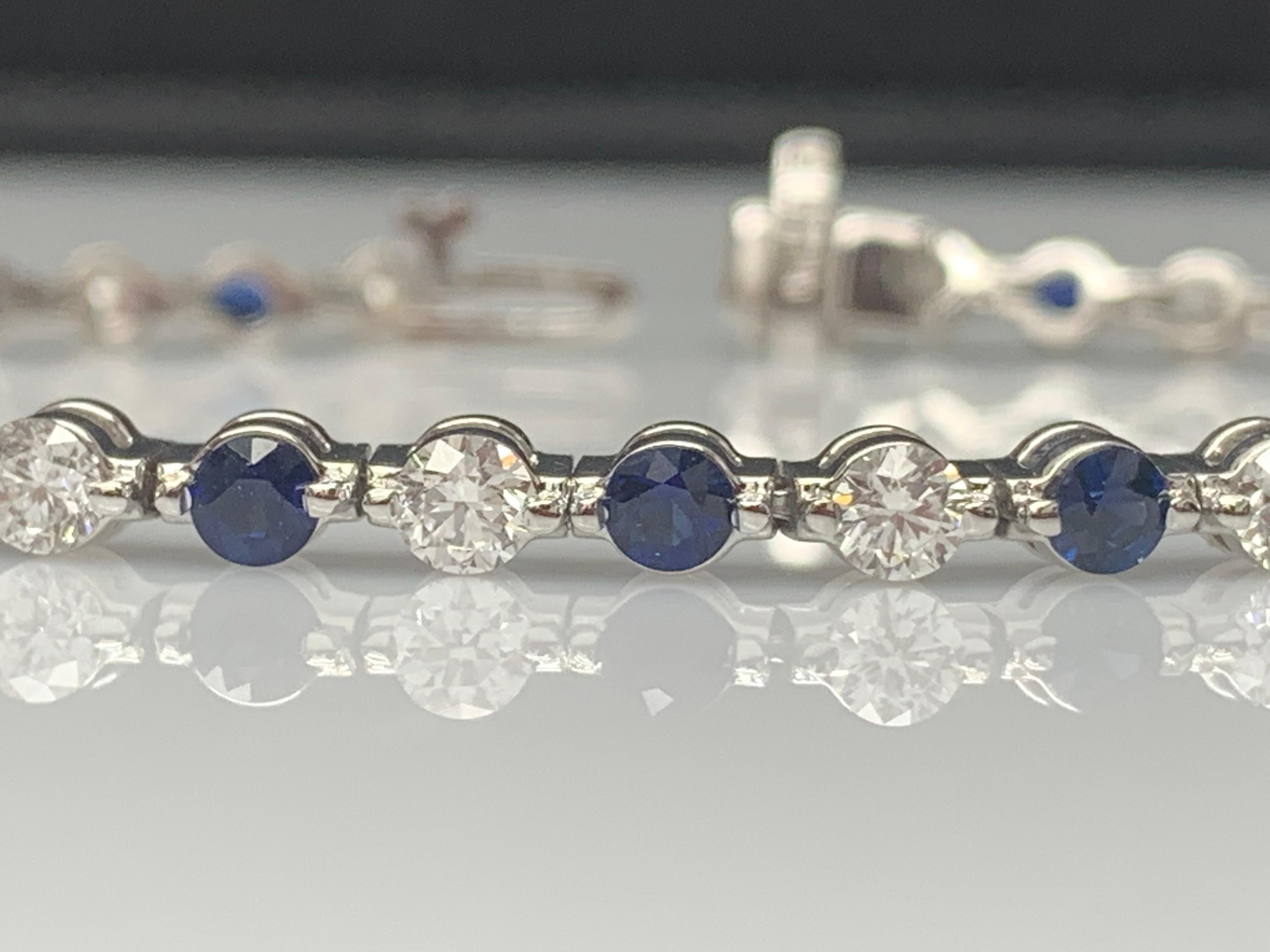 A stunning bracelet set with 18 Vibrant Blue sapphires weighing 3.18 carat total. Alternating these blue sapphires are 18 sparkling brilliant-cut round diamonds weighing 2.88 carats in total. Set in polished 14k white gold. Double lock mechanism for