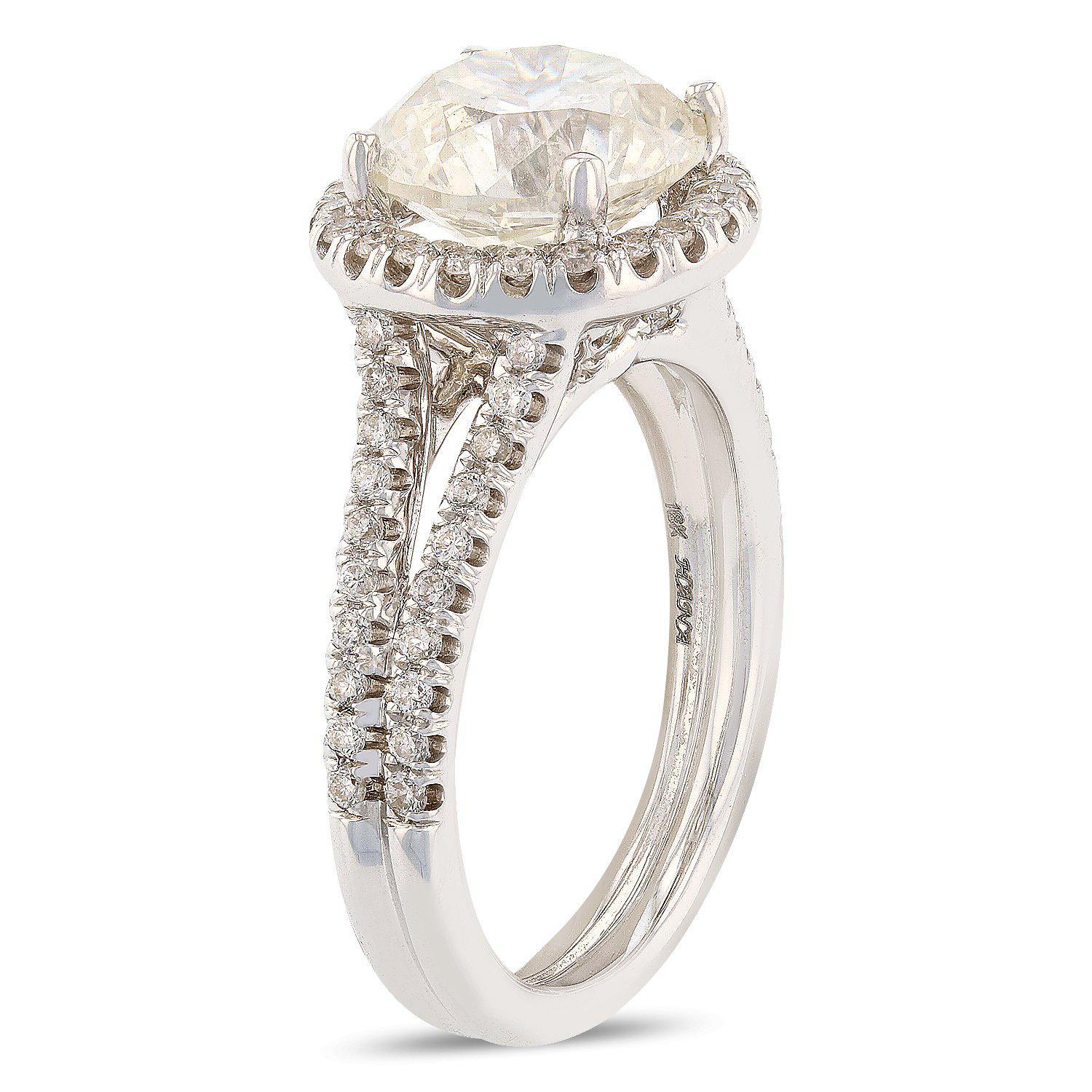 One electronically tested 18KT white gold ladies cast diamond unity ring with a bright polish finish. The featured diamond is set within a diamond bezel supported by a diamond accented under gallery and diamond set split shoulders, completed by a