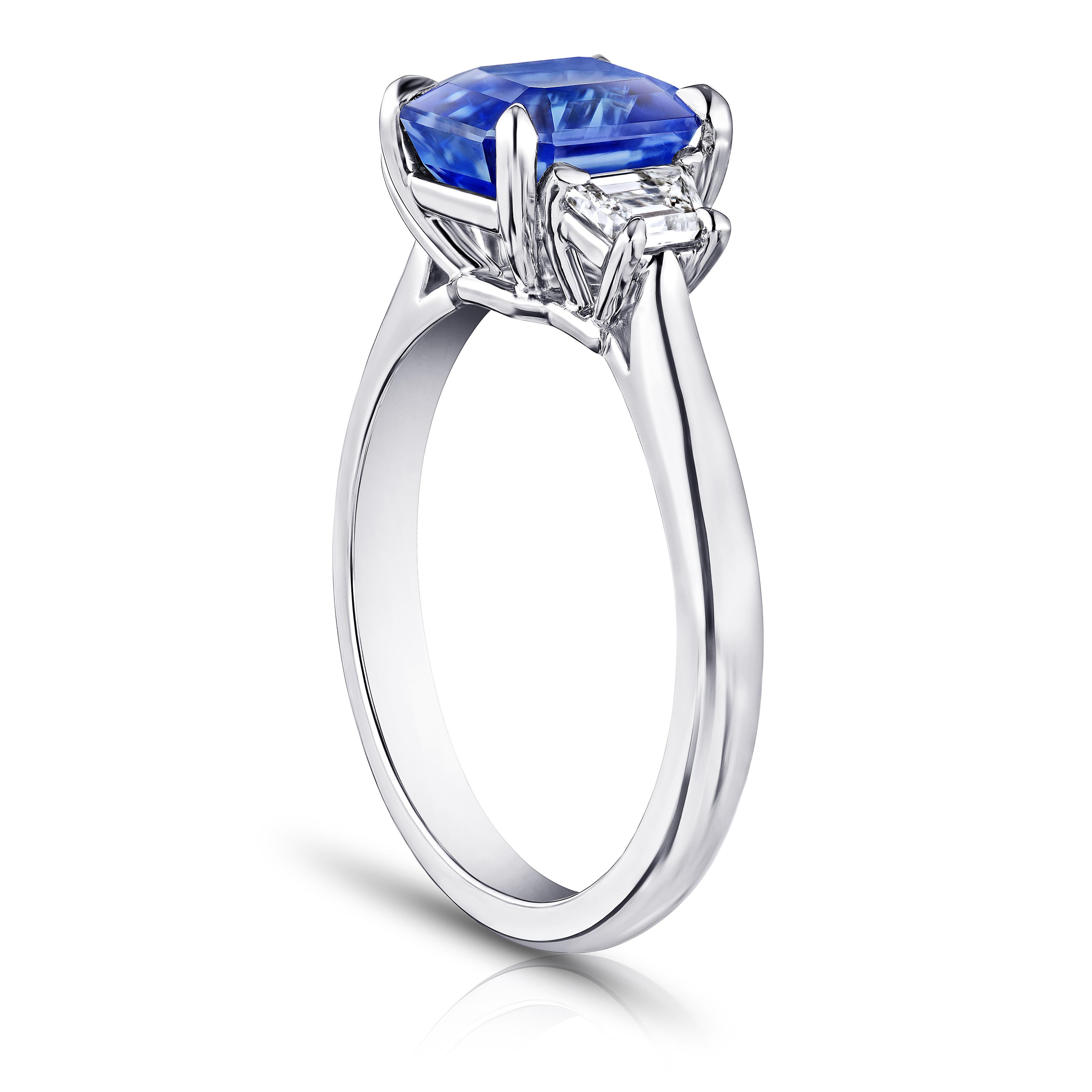 3.18 carat emerald cut light blue sapphire with trapezoid step cut diamonds .46 carats set in a platinum ring. Ring is currently a size 7. Free resizing to you finger size.  