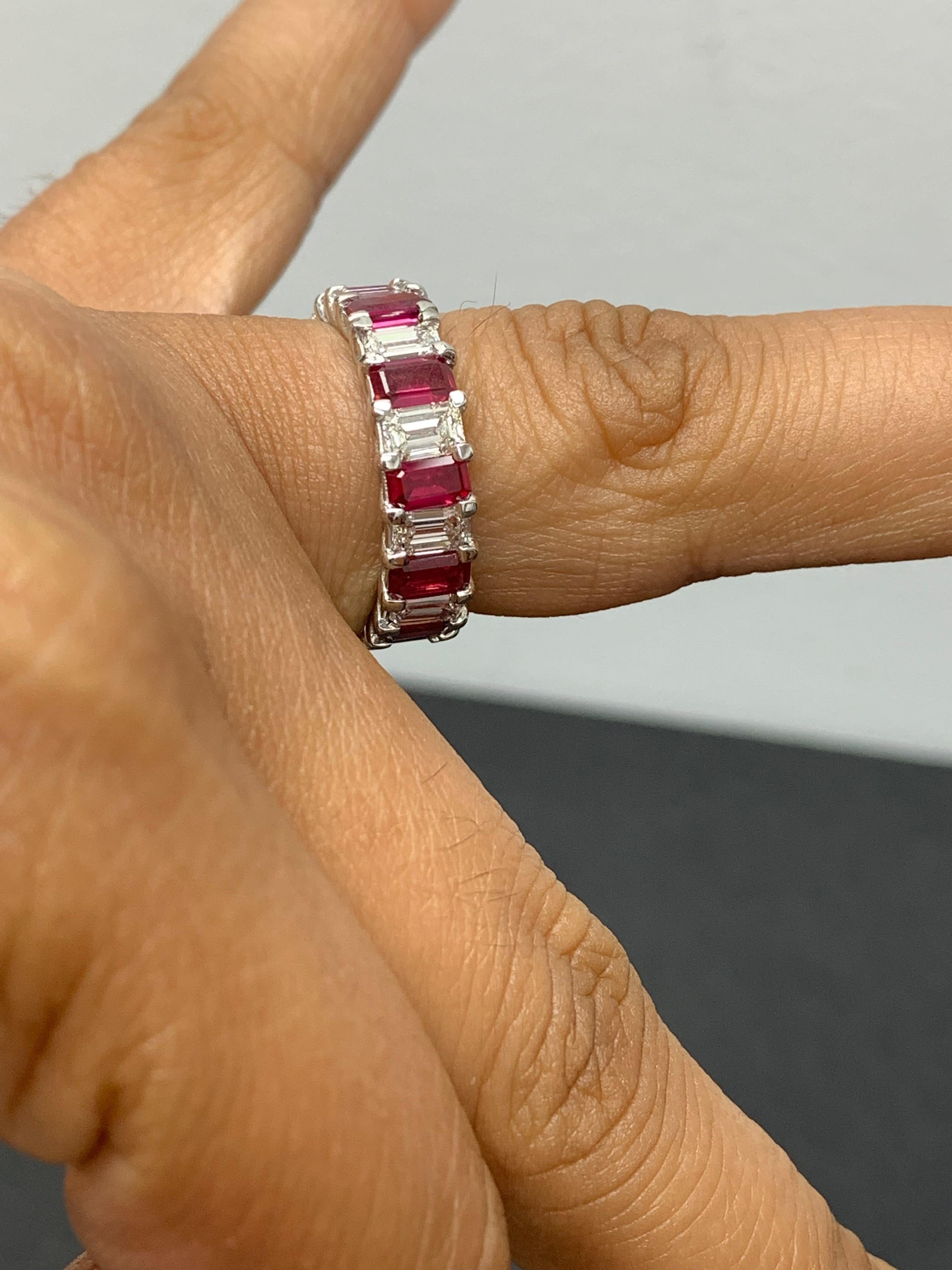 A beautiful and vibrant eternity wedding band style showcasing emerald cut rubies and emerald cut diamonds set alternating to each other in a shared prong 14K white gold mounting. 11 emerald cut Diamonds weigh 1.88 carats and 11 emerald cut rubies