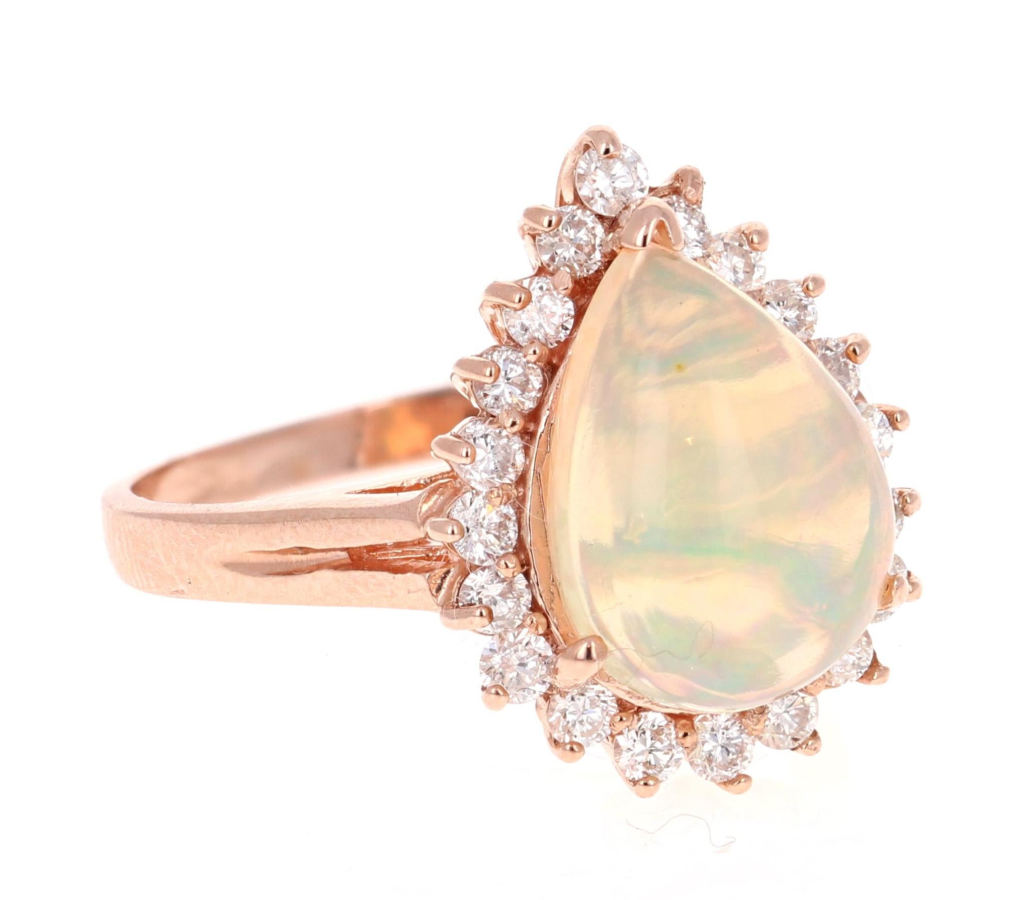 Opulent 3.18 Carat Opal and Diamond Ring in 14K Rose Gold.
The beautiful Pear Cut Opal with its striking flashes of color weighs 2.59 carats. It is surrounded by 20 Round Cut Diamonds that weigh 0.59 carats.  The total carat weight of the ring is