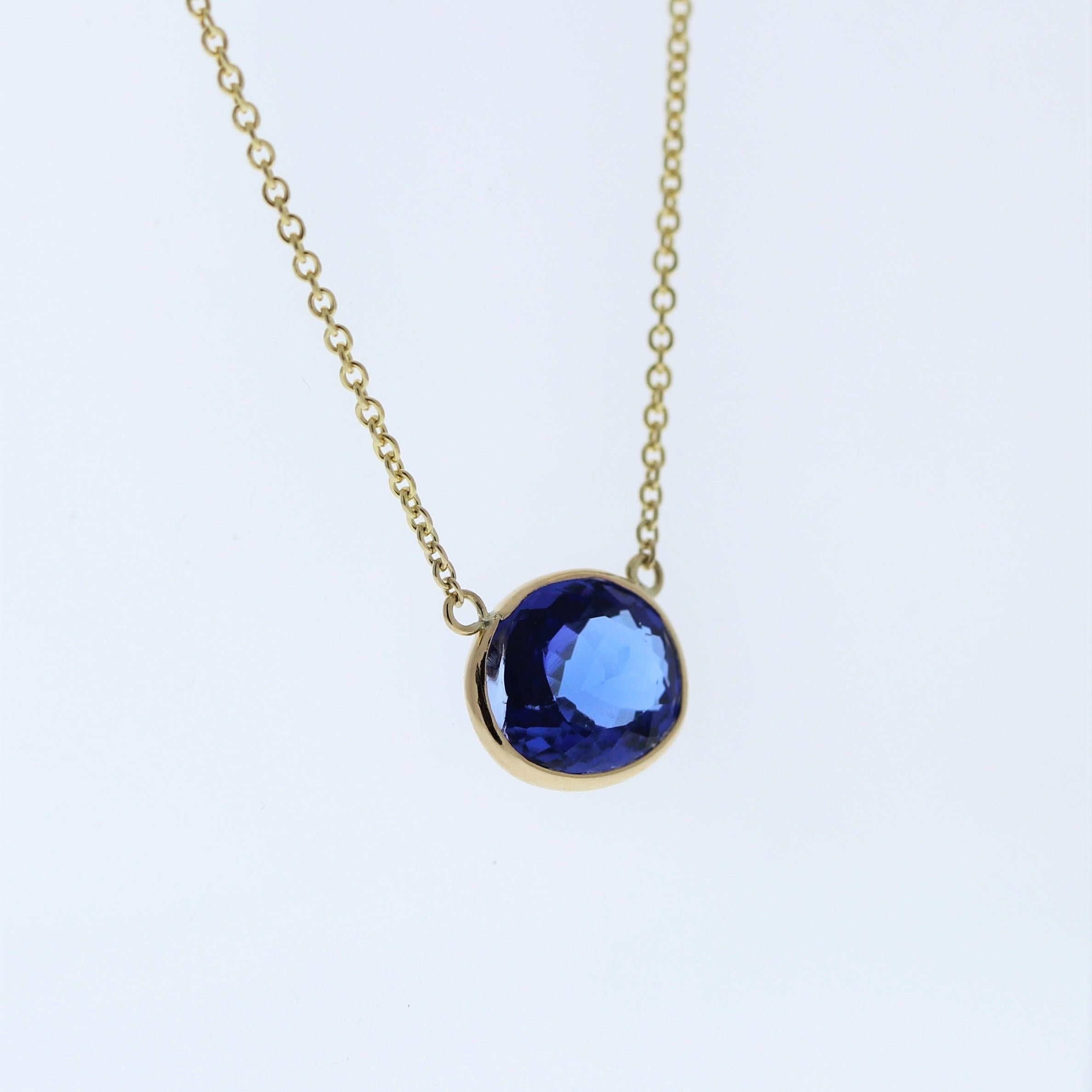 The necklace features a 3.18-carat oval-cut tanzanite set in a 14 karat yellow gold pendant or setting. The oval cut and the mesmerizing blue-violet color of the tanzanite against the yellow gold setting are likely to create a luxurious and
