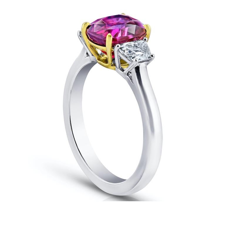 3.18 carat red cushion ruby with trapezoid diamonds .69 carats set in a platinum with 18k yellow gold ring
