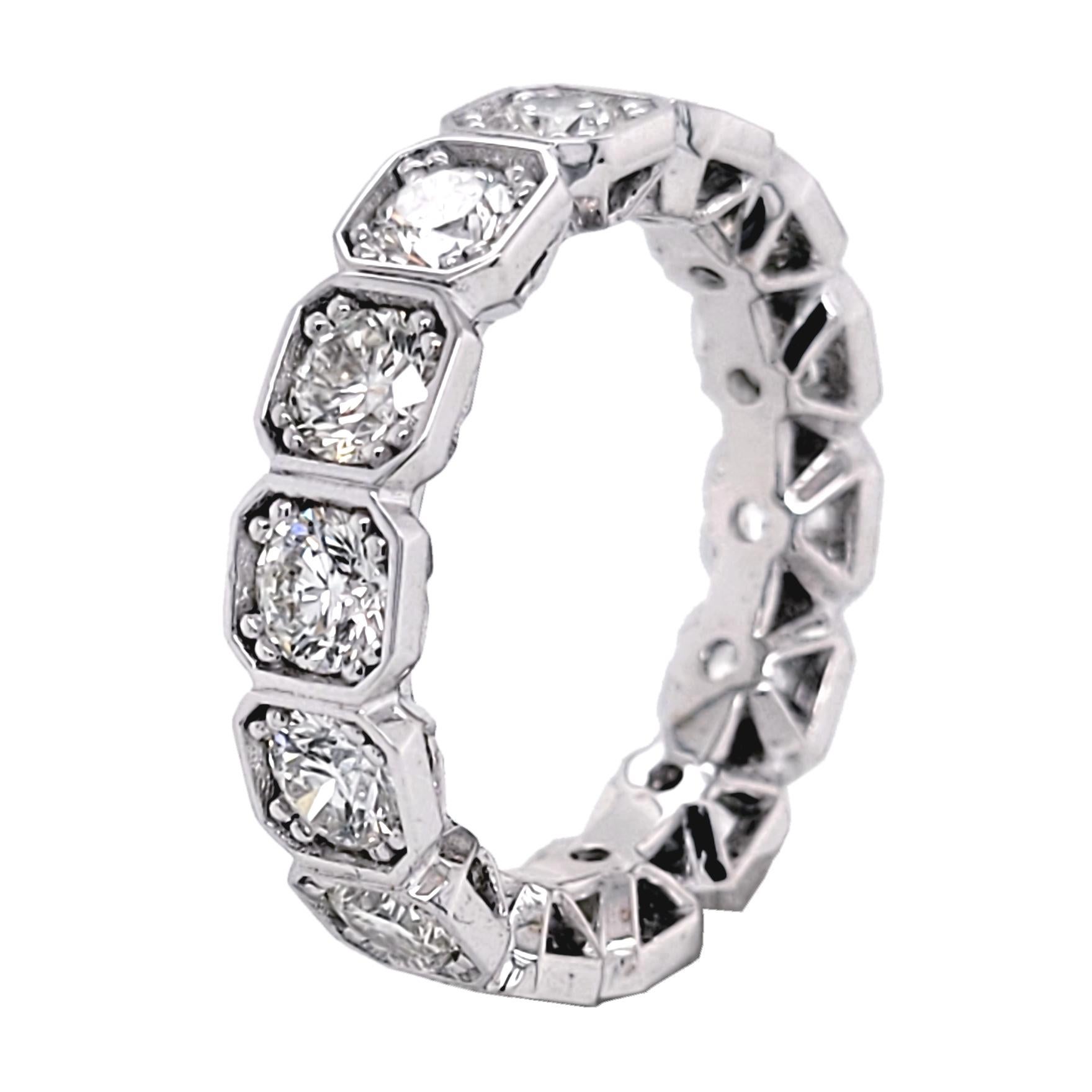 This beautiful Eternity Ring is made in 18 Karat Gold with 14 perfectly matched 3.9 mm Round Brilliant Diamonds Set in Hexagon Shaped segments.
Total Weight of diamonds: 3.18 Ct  SI/F-G
Total Weight of the Ring: 5.2 Gr 18K White Gold
Ring Size: 6.5