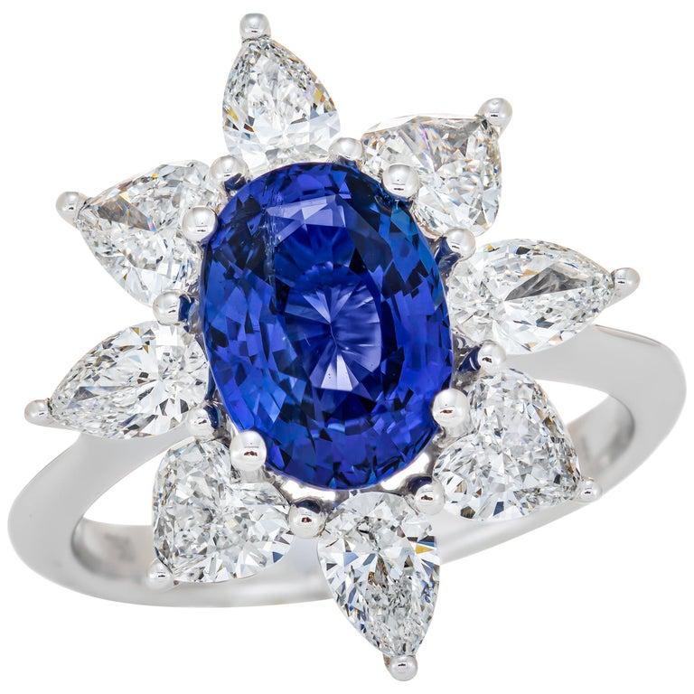 Breathtaking Ceylon (Sri Lanka) Sapphire and diamond ring. 
Set with an oval-shaped sapphire weighing 3.18 carats, framed with diamonds totaling 1.91 carats and mounted in 18k white gold setting, ring size 6½.
Accompanied by a report from the Gem
