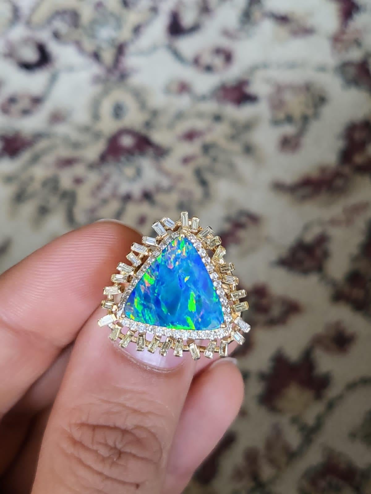 A very gorgeous and one of a kind, Australian Doublet Opal Ring set in 18K Yellow Gold & Diamonds. The weight of the Australian Doublet Opal is 3.18 carats. All the pictures of the ring are taken in plain daylight, and no other lightning equipment