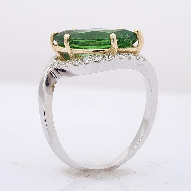 Eye motifs have been known to ward away evil and this delicate ring, set with a large Tsavorite garnet weighing 3.18 carats, does just the same. The vibrant, envious green that gets the perfect amount of light from both the prong setting and the