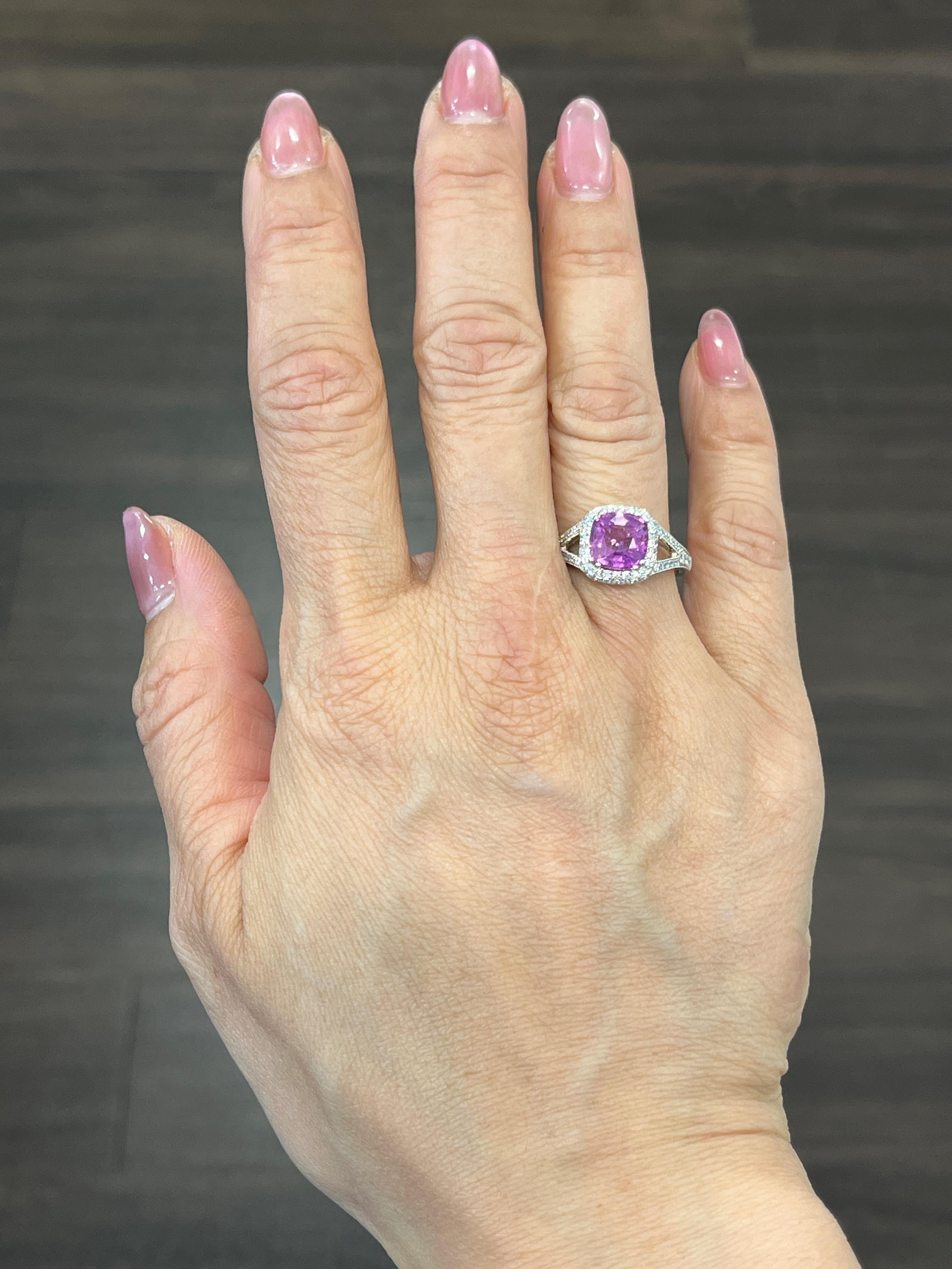 Check out this gorgeous 18k white gold ring set with a natural pink sapphire weighing 2.55 ct. Surrounding the pink sapphire are 78 round cut diamonds that weigh a total of 0.63 ct. The diamonds are G/H in color and VS2/SI1 in clarity. This ring is