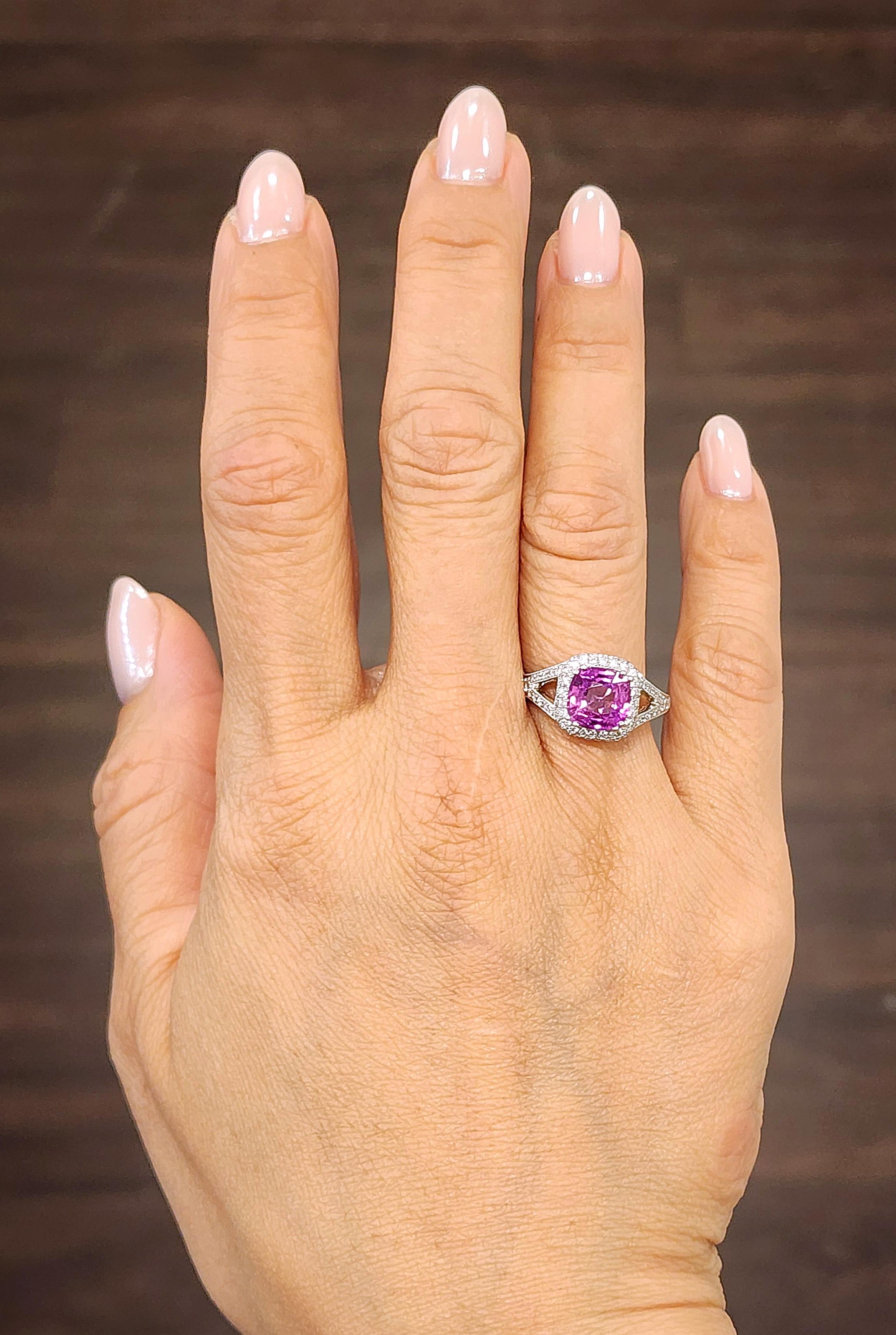 Check out this gorgeous 18k white gold ring set with a natural pink sapphire weighing 2.55 ct. Surrounding the pink sapphire are 78 round cut diamonds that weigh a total of 0.63 ct. The diamonds are G/H in color and VS2/SI1 in clarity. This ring is