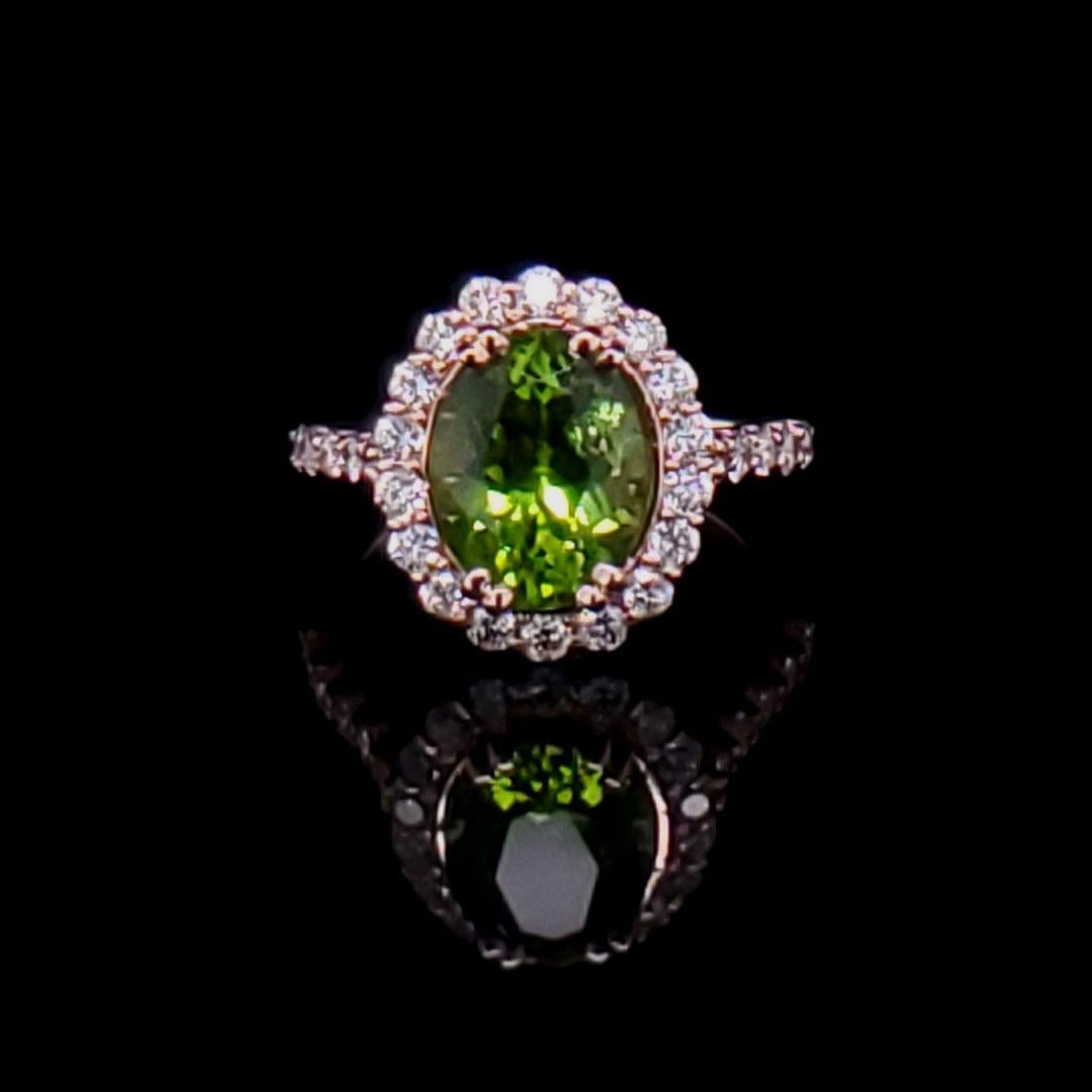 This is a breathtaking piece of jewelry! An exquisite Arizona Peridot is set in 14k Rose Gold with bright and lively diamonds in a halo around the stone and down the sides of the ring. If you want to feel like royalty, this is your ring! The style