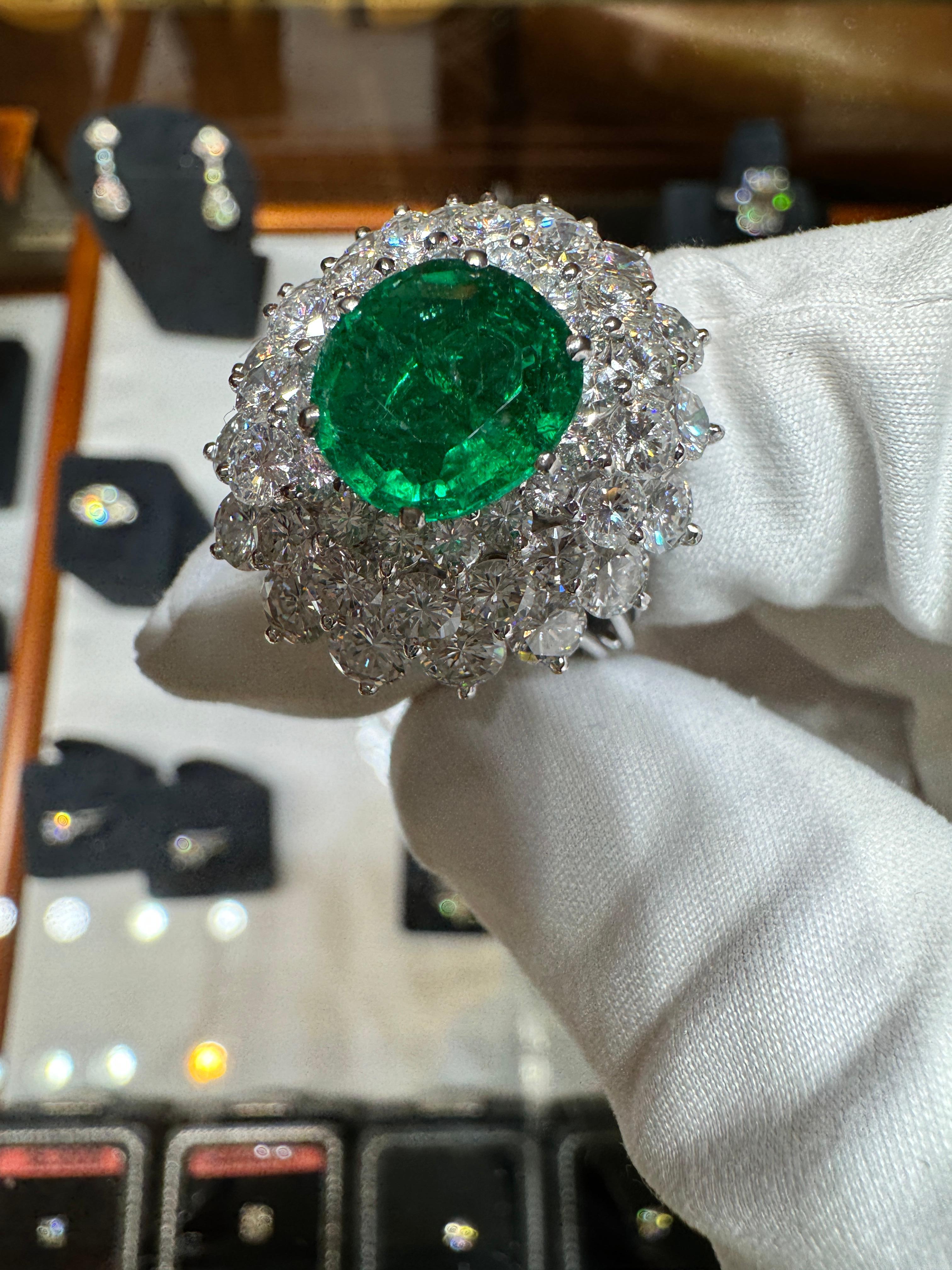 3.19 Carat Oval Cut Emerald Minor Oil & Diamond Cluster Platinum Vintage Ring For Sale 1
