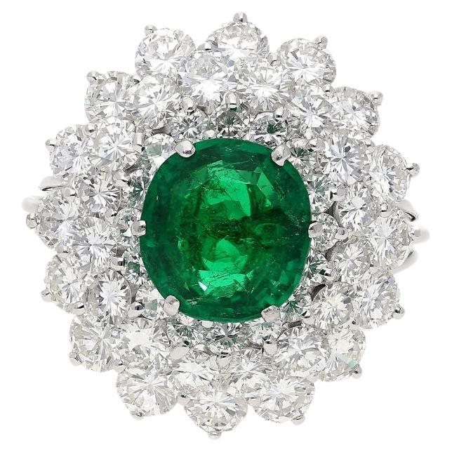 3.19 Carat Oval Cut Emerald Minor Oil & Diamond Cluster Platinum Vintage Ring For Sale