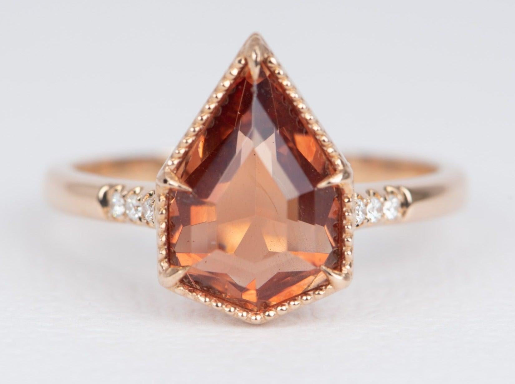 ♥ This is a statement ring featuring a large shield-shaped Oregon sunstone and diamond accents on the band

♥ This stone is purchased directly from the mine owner who mined and faceted this gemstone from his Oregon sunstone mine. This stone is fully