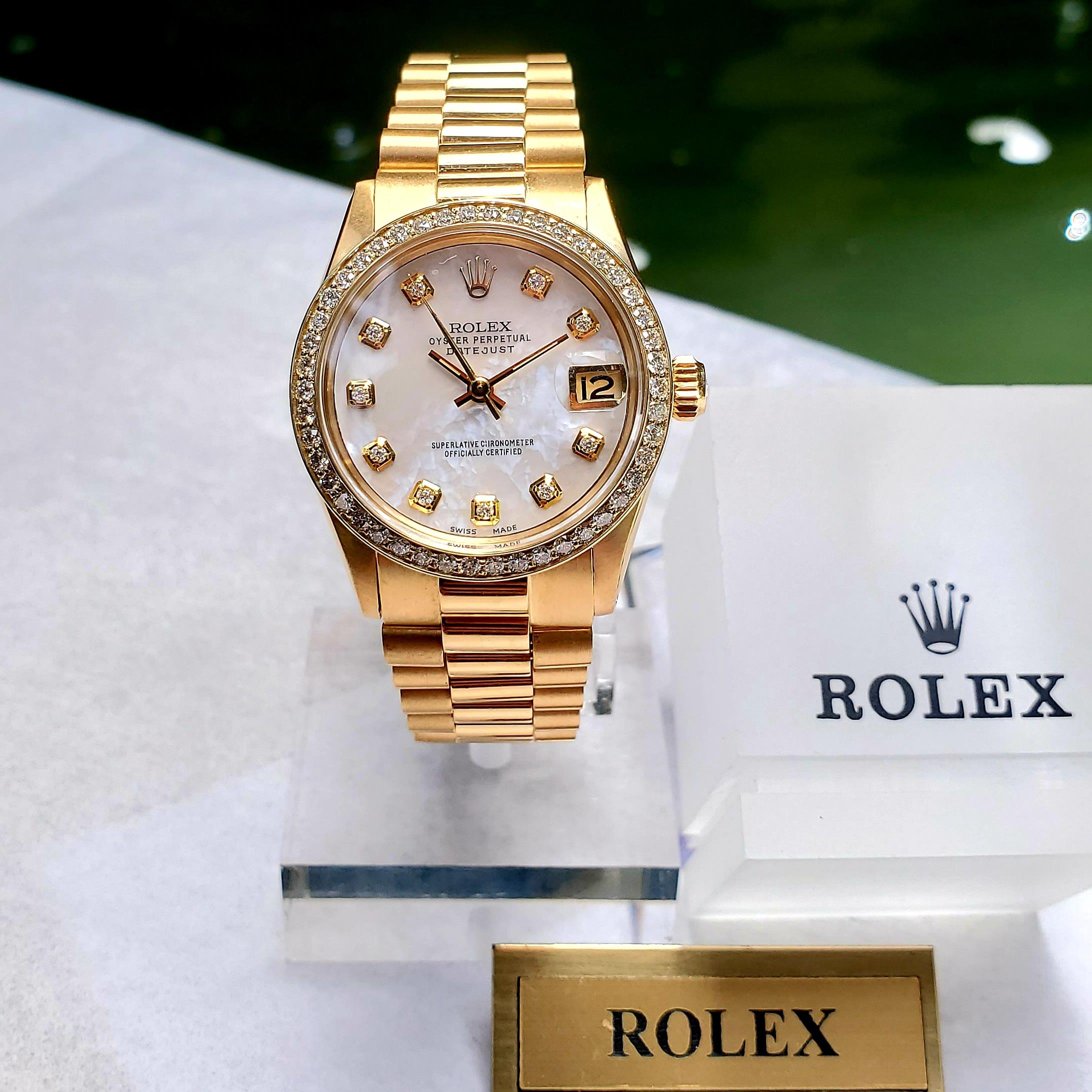 Stunning Rolex 31mm Midsize Datejust with Presidential link bracelet. This timepiece features a mother of pearl diamond dial and diamond bezel. Watch was reviewed and all necessary servicing was completed by a Rolex Authorized watchmaker. There is a