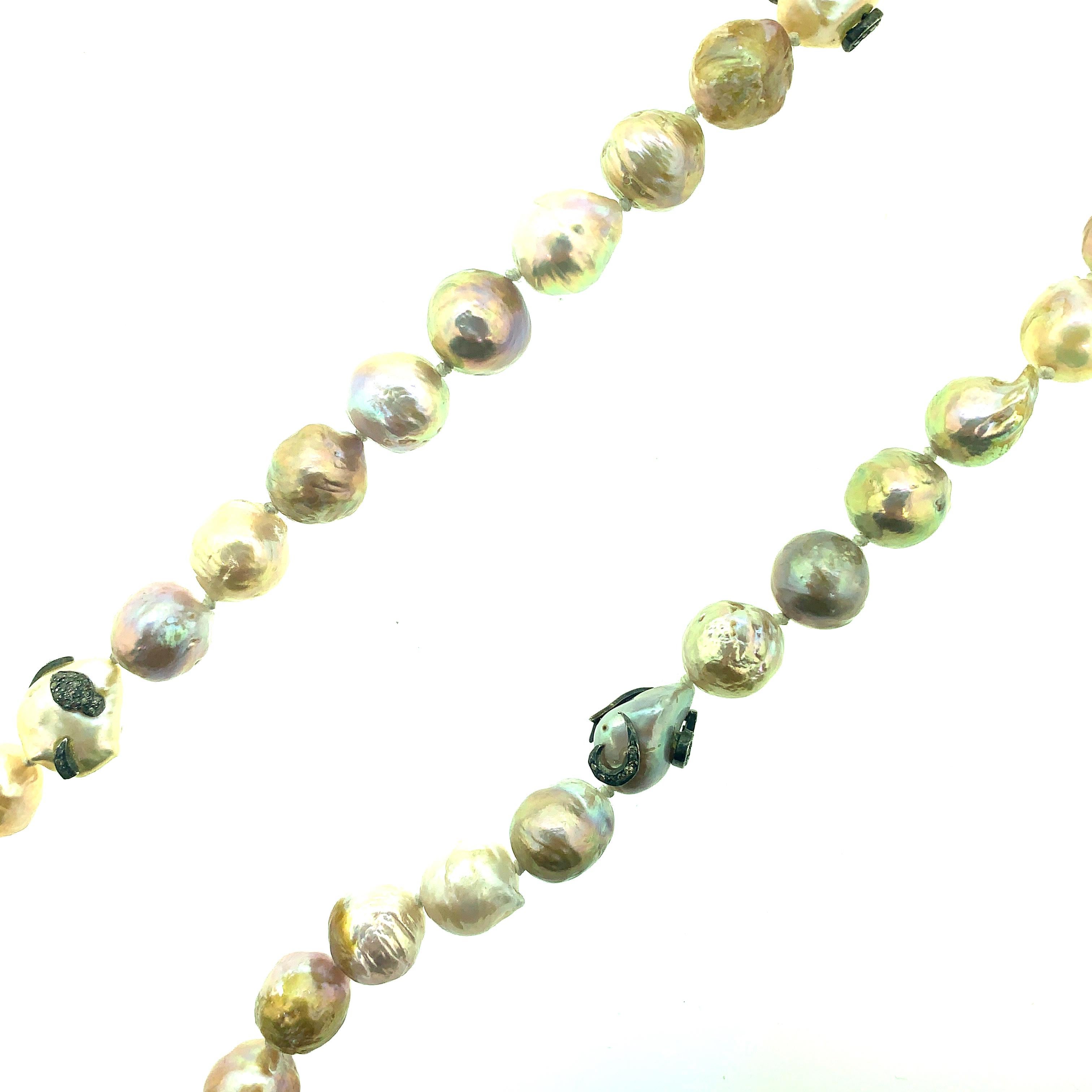 32 Inch Long 649.50 ct Freshwater Pearl (all real and natural) Necklace set in Oxidized Sterling Silver with 0.75 ct Pave Champagne Diamonds on three pearls. The necklace is made with knotted threads in white with pearl in various shades of pink,