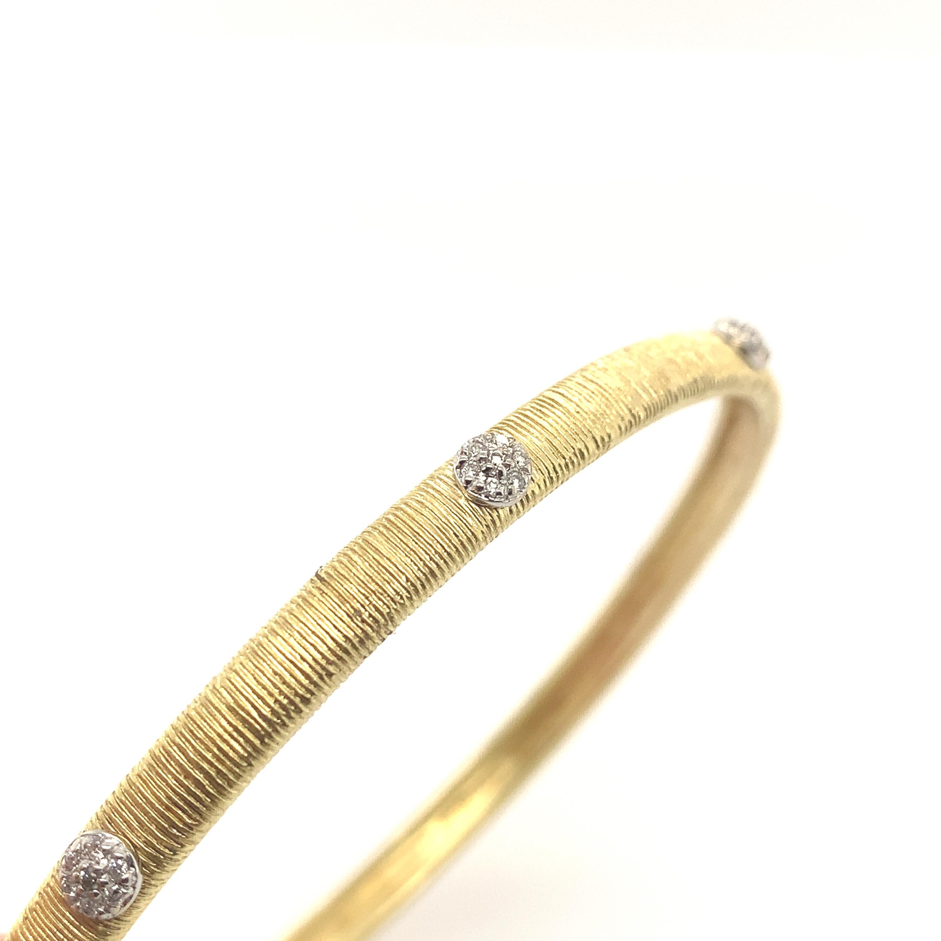 A unique bangle bracelet crafted by Meira T using the Florentine technique of feather thin sophisticated hand engraving. This bracelet is embellished with 0.32 carats of diamonds featuring (8) eight diamond floral motif elements giving the bangle a