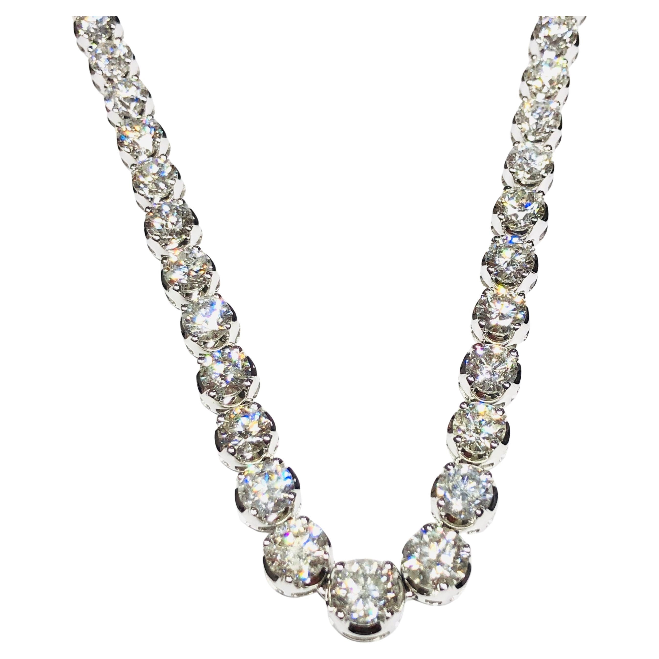An impressive classic Riviera Tennis Necklace a line that features a substantial total Diamond weight of 32.42 Carats in beautifully graduated Round Brilliant Cut gems with a sparkly white colour H clarity SI eye clean, each stone has a four-claw