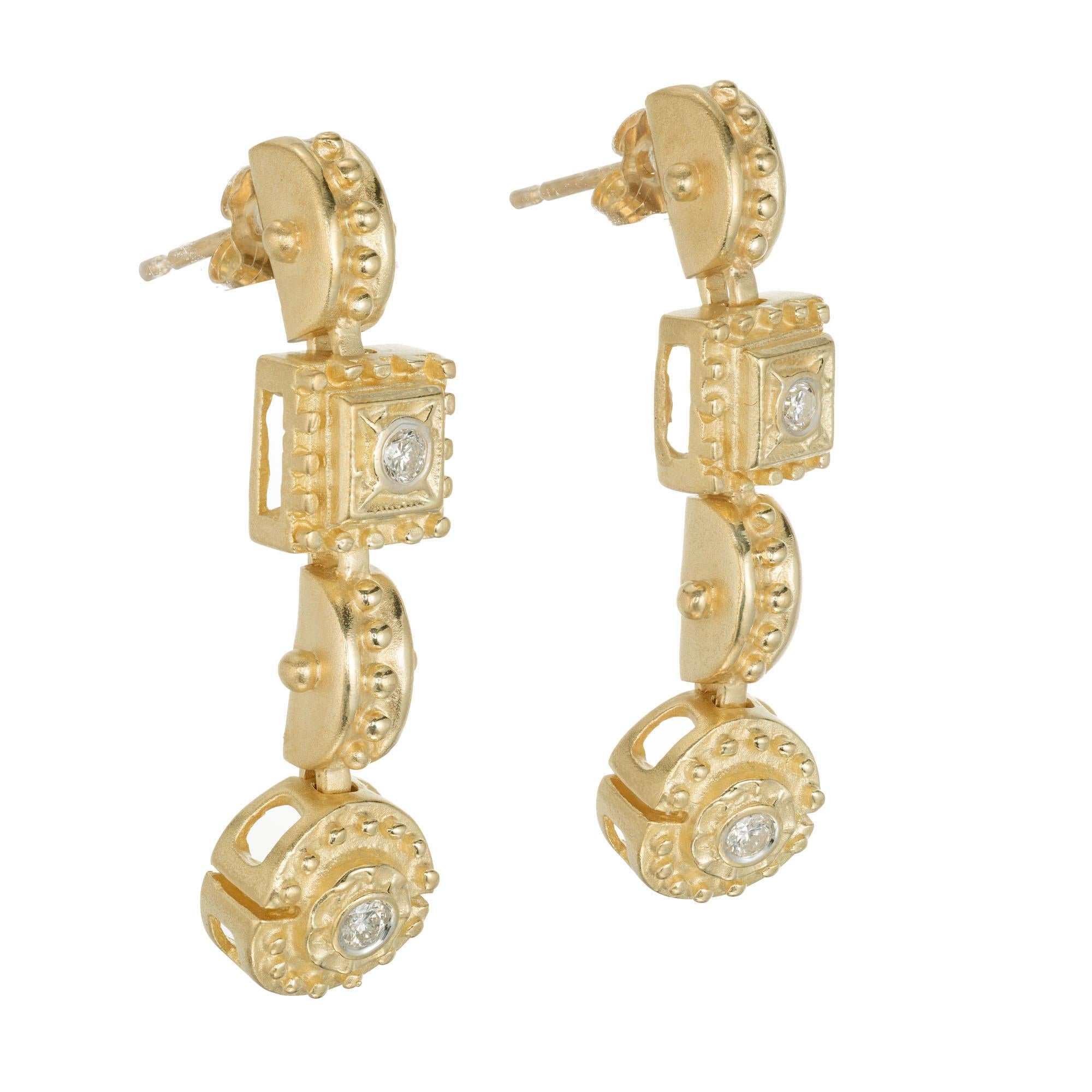 Etruscan style diamond dangle earrings in 14k yellow gold. 

4 round brilliant cut diamonds G SI, approx. .32cts
14k yellow gold 
Tested: 14k
10.2 grams
Top to bottom: 36.2mm or 1 7/16 Inch
Width: 9.49mm or 5/16 Inch

