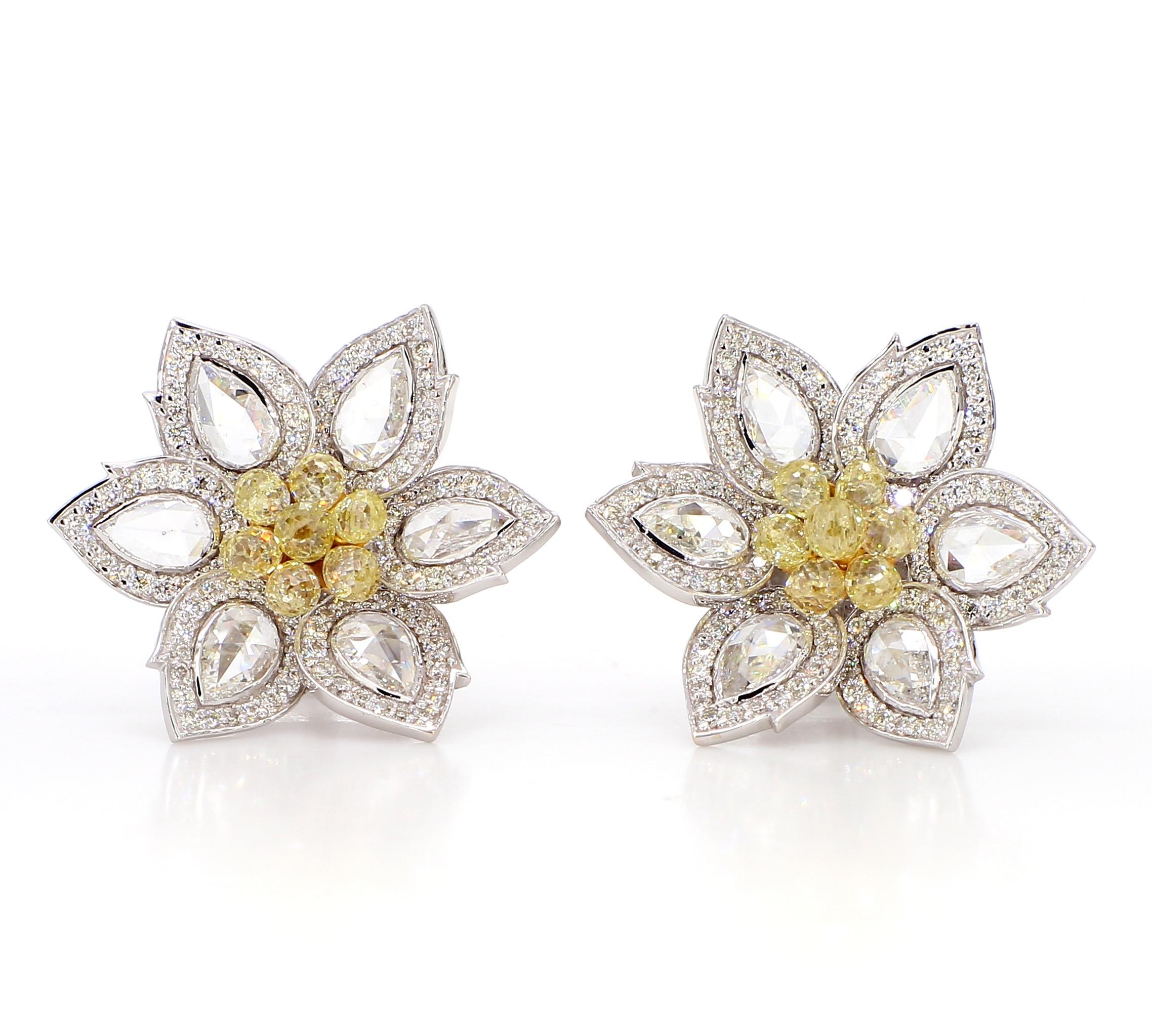 The earrings are a captivating floral design, featuring 1.31 carats of yellow diamonds with a rose cut. The center showcases a cluster of yellow diamonds, surrounded by white diamonds totaling 0.93 carats, all with a round cut. The diamonds are set