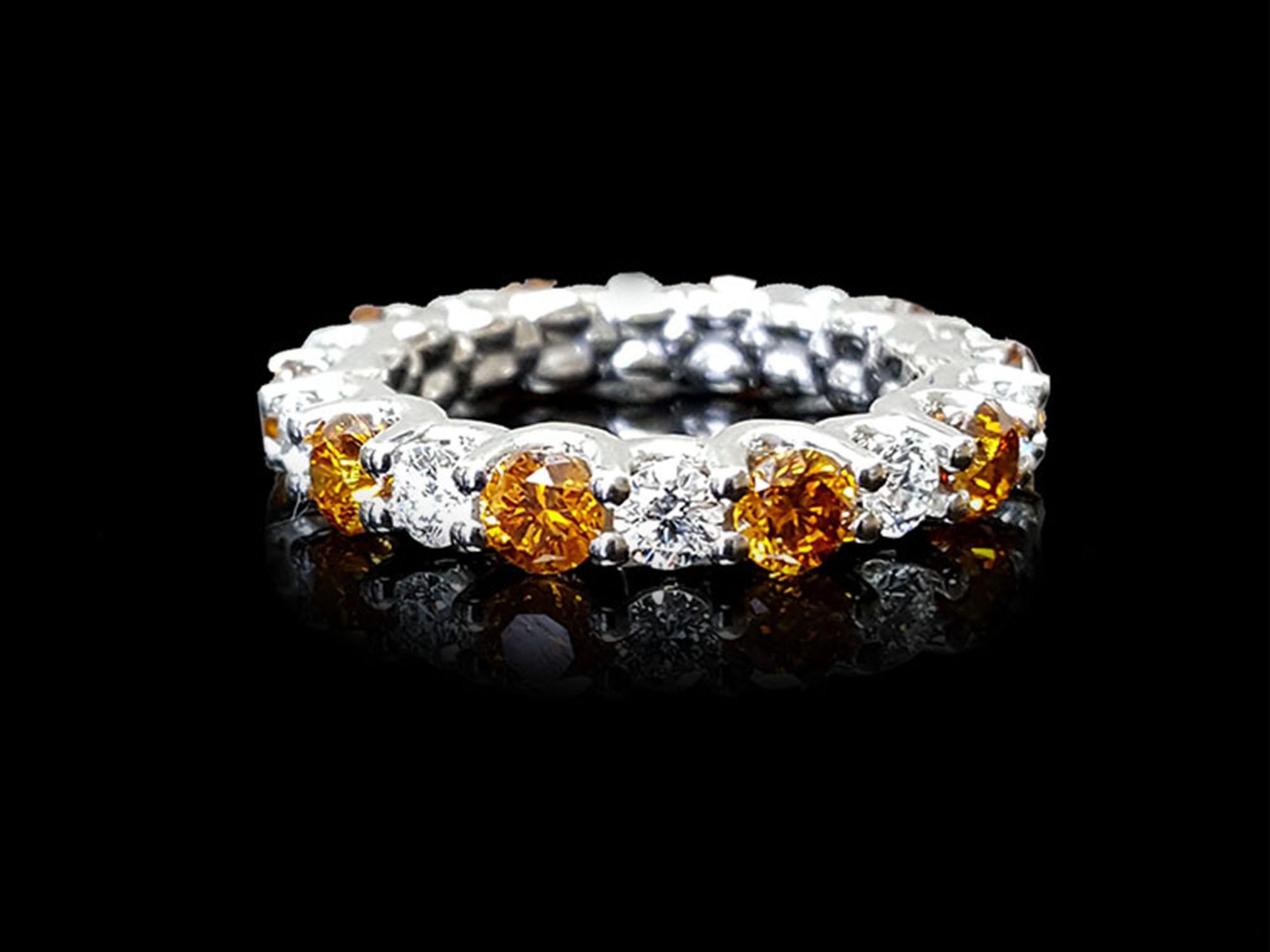Presenting an exceptional wedding band style that elegantly alternates between round brilliant cut Orange diamonds and round brilliant white diamonds, evoking a captivating interplay of fiery hues and radiant brilliance. Adorning this exquisite