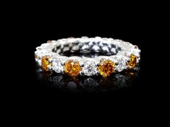 3.2 Carat Round Cut Orange and White Diamond Eternity Band Set in Platinum.