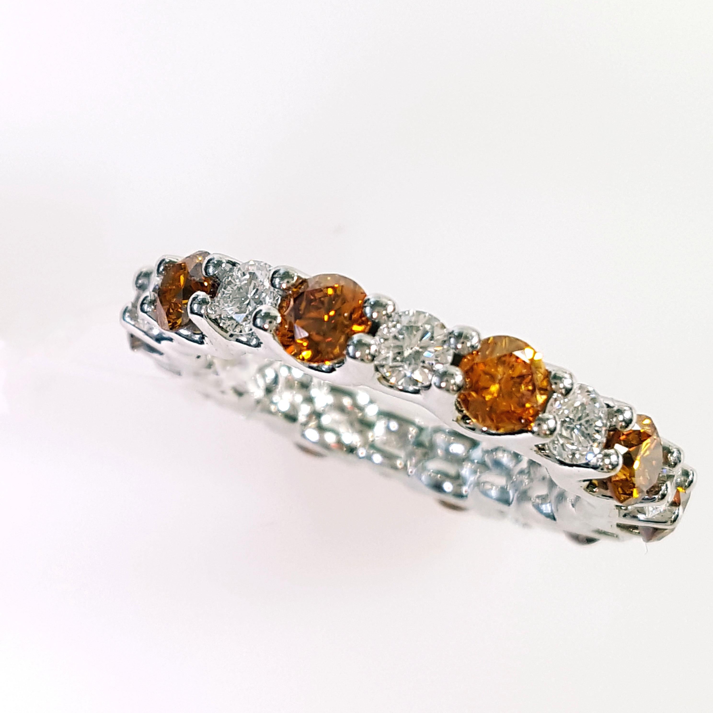 Contemporary 3.2 Carat Round Cut Orange and White Diamond Eternity Band Set in Platinum. For Sale