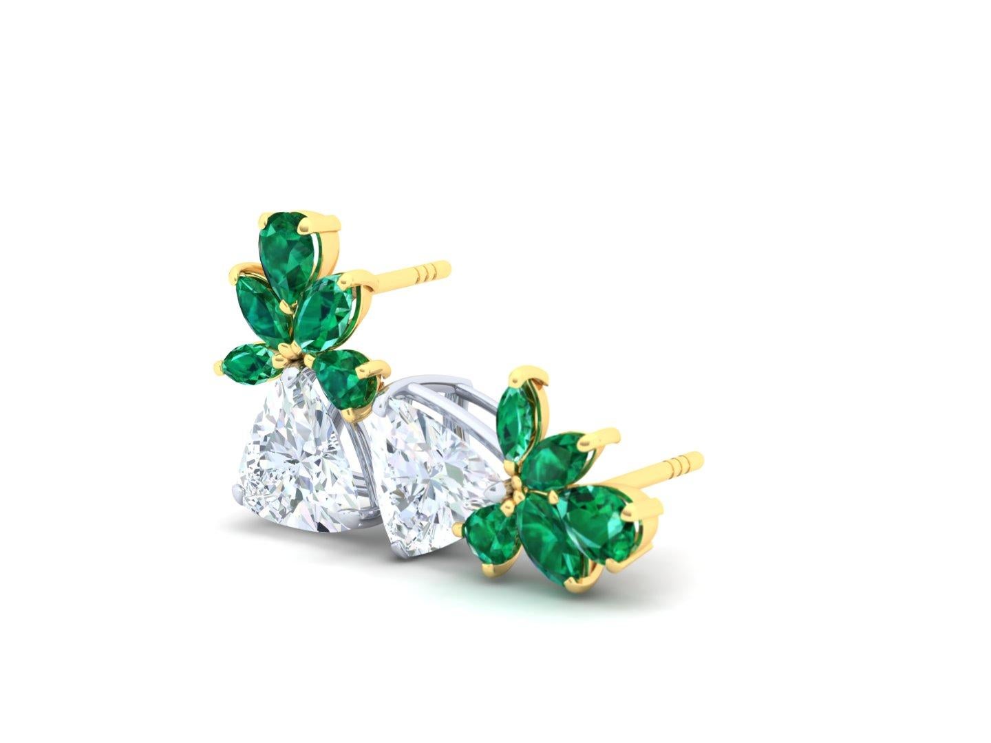 These classic styled earrings have the perfect combination of crisp white trillion cut diamonds paired with rich deep green emeralds.  The tops of these earrings are forged from 18 k yellow gold and pair with the green perfectly.  Below the green