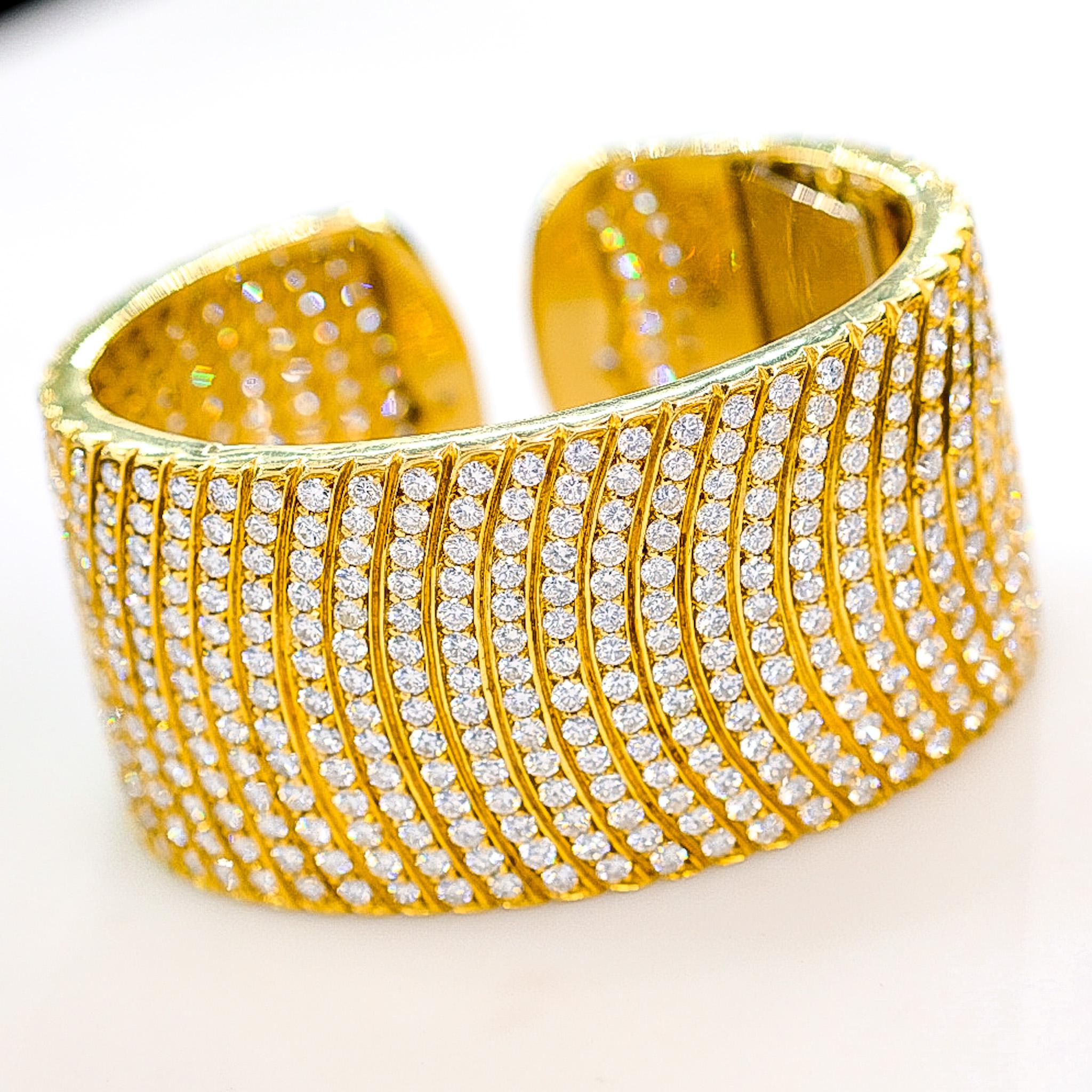 This is a stunning diamond cuff bracelet made in 18k yellow gold encrusted with 32 carats of round brilliant cut diamonds. This cuff bracelet is a luxurious piece and is exceptionally brilliant. 
You will love this bracelet when you open the box: