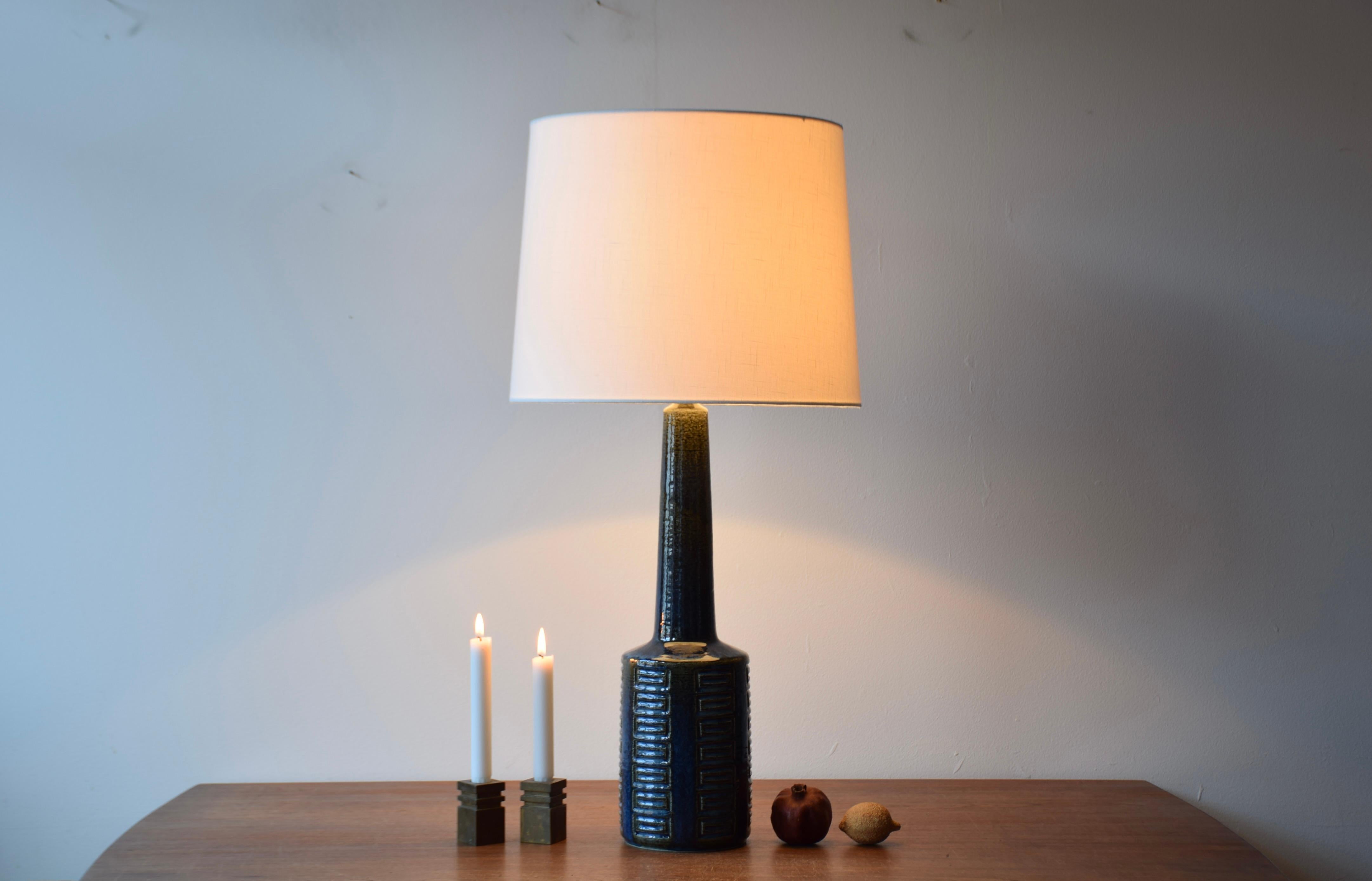 Very tall Danish Midcentury ceramic table lamp from the ceramic workshop Palshus. 

The lamp was designed by Per Linnemann-Schmidt and manufactured circa 1960s or early 1970s.

It is made with chamotte clay which gives a rough and vivid surface. The