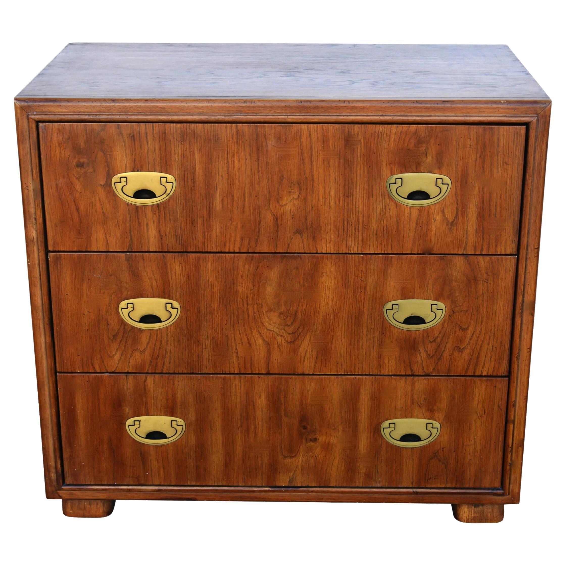 Campaign style Drexel dresser
circa 1970s

Drexel Passage Series dresser in flaxen flared grain. Brass recessed pulls. This dresser provides compact yet efficient 3 drawer storage. Drawers roll out effortlessly on metal glides. Measure: 32”.