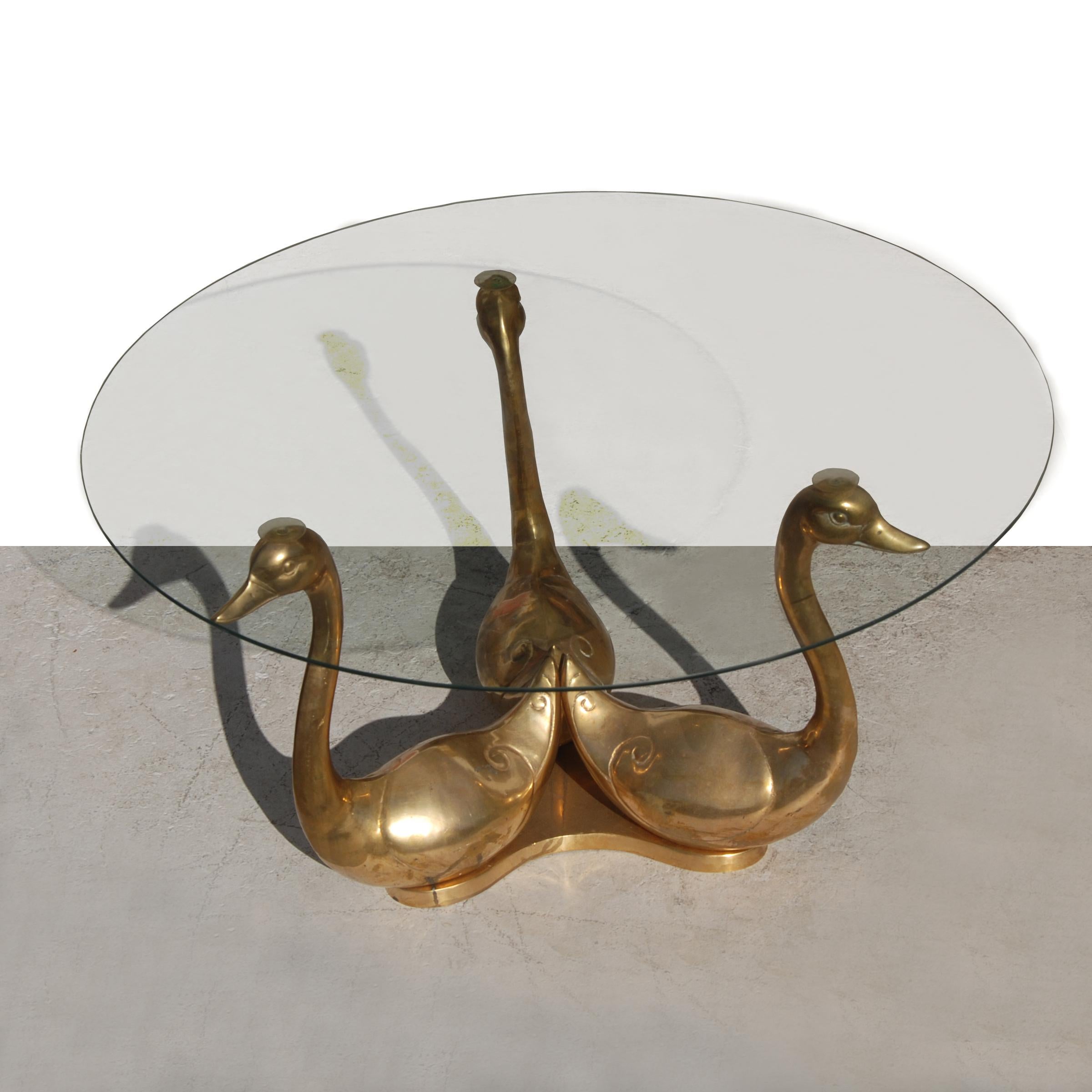 Maison Jansen style bronze swan cocktail table

Three-seated brass swans support a glass top. A rich patina gives an antique feel to the piece.
Measures: 32