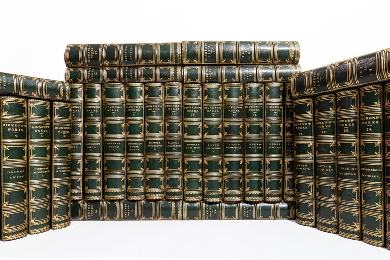 32 Volumes. Charles Dickens, Works of Charles Dickens. Bound in 3/4 dark green morocco. Green morocco boards. Raised bands. All edges marbled. Marbled boards. Illustrated Library Edition. Illustrations by George Cruikshank. Published: London;