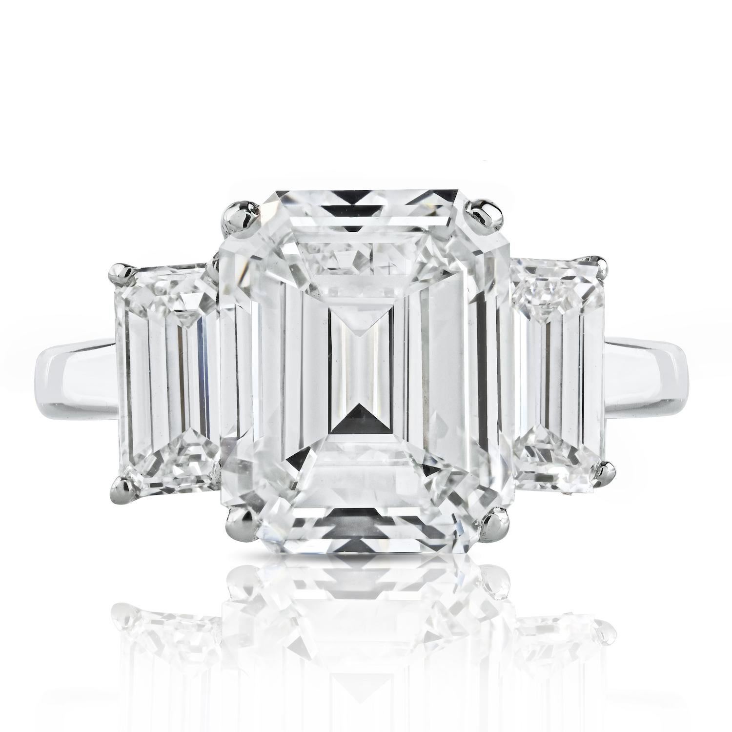 Immerse yourself in the timeless beauty of this 3.20-carat Emerald Cut Diamond F/VS1 Three Stone Engagement Ring, a testament to exquisite craftsmanship and enduring elegance. 

Meticulously handmade, this stunning ring features three emerald cut