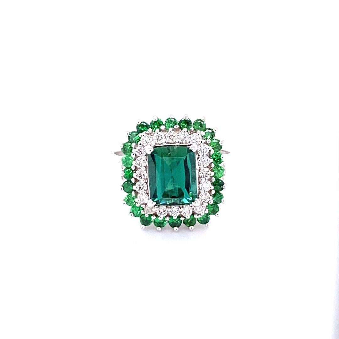 3.20 Carat Green Tourmaline Tsavorite Diamond Gold Engagement Ring

This gorgeous and unique ring has a beautiful Emerald cut Green Tourmaline weighing 2.08 carats and is surrounded by a double halo of 21 Round Cut Diamonds weighing 0.37 carats