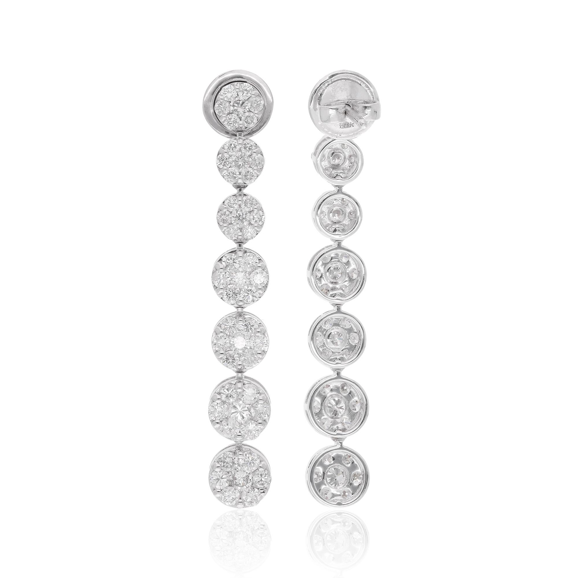 It appears you're describing a pair of dangle earrings made from 18 karat white gold, featuring pave-set diamonds with a total weight of 3.20 carats. These earrings are also characterized as handmade jewelry, which often suggests a higher level of
