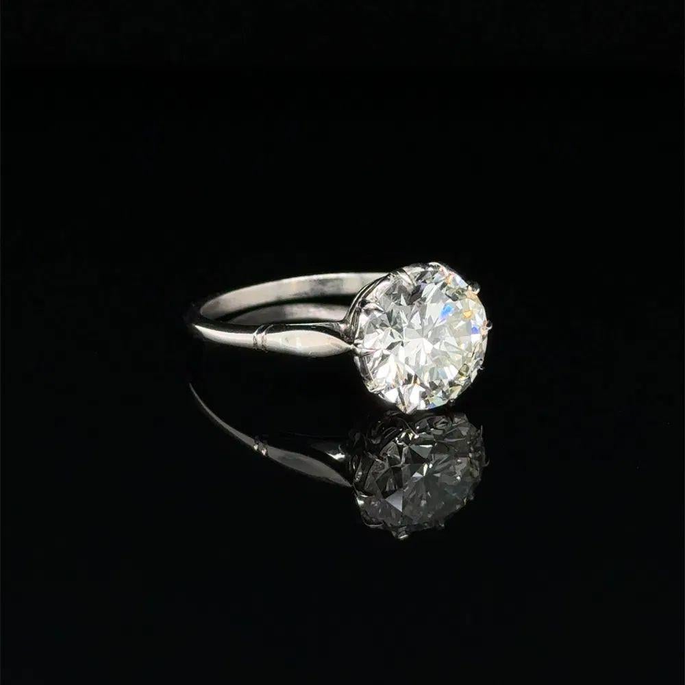 Simply Beautiful! Diamond and Platinum Solitaire Statement Cocktail Ring. Centering a securely nestled Hand set 3.20 Carat Transitional Round Brilliant Cut Diamond. Hand crafted Platinum mounting. Measuring approx. 1” l x 0.8” w x 0.4” h. Ring Size