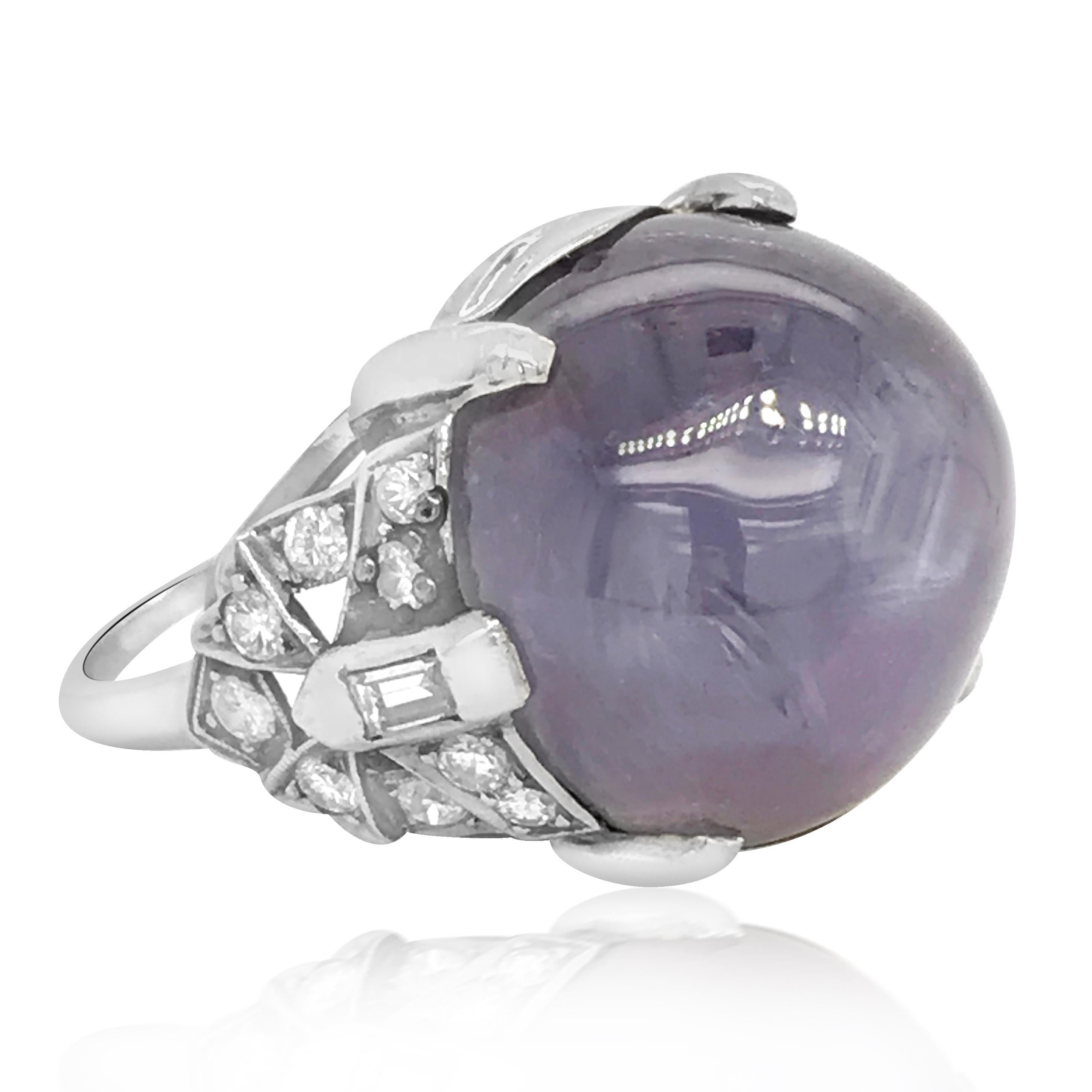 This stunning antique art deco star sapphire and diamond ring is crafted in solid platinum, weighing 12.8 grams and measuring 20mm wide and 13mm high. Exposing a one prominent prong-set, round star sapphire weighing approx. 32.00carats. Surrounded