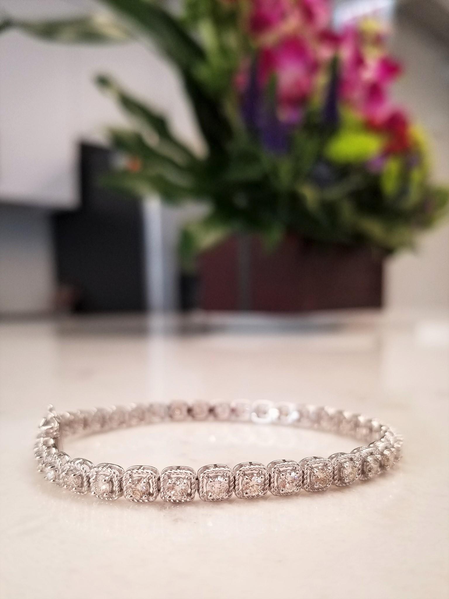 Twisted rope square-shaped links make this gorgeous tennis bracelet different. 37 round brilliant cut diamonds, prong set, and nestled in the center total 3.20 carats. Geometry meets timeless craftsmanship with this intriguing tennis bracelet