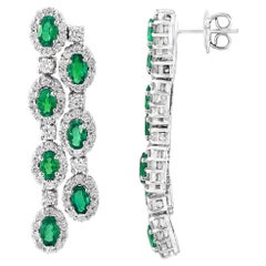 3.20 Carats Oval Cut Emeralds and Diamond Halo Dangle Earring in 14K White Gold