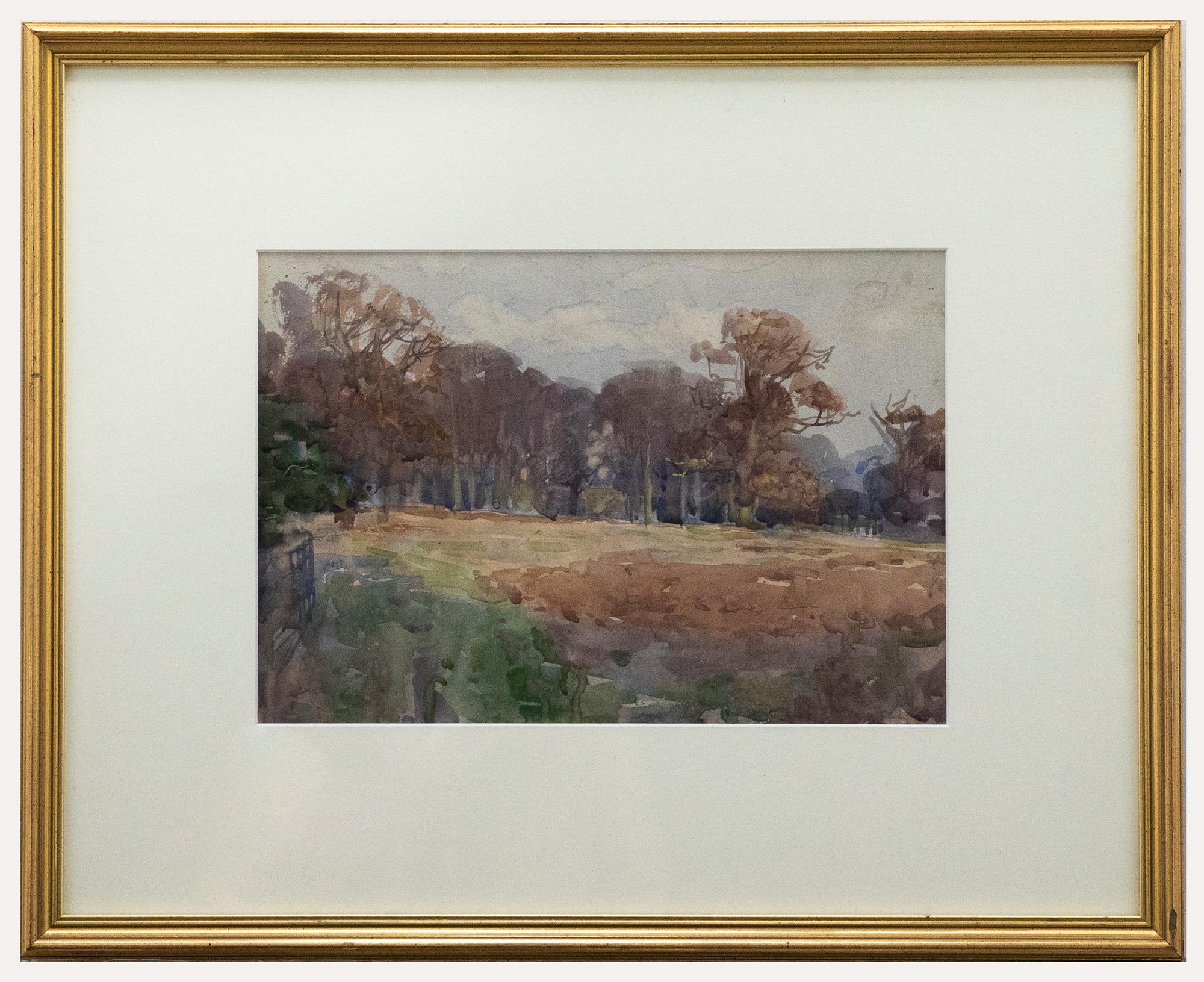 This early 20th century watercolour, attributed to Henry Charles Brewer RI (1866-1950), depicts a large beach wood met by cultivated fields. The watercolour has been elegantly mounted in a gilt-effect frame. On watercolour paper. On paper. 