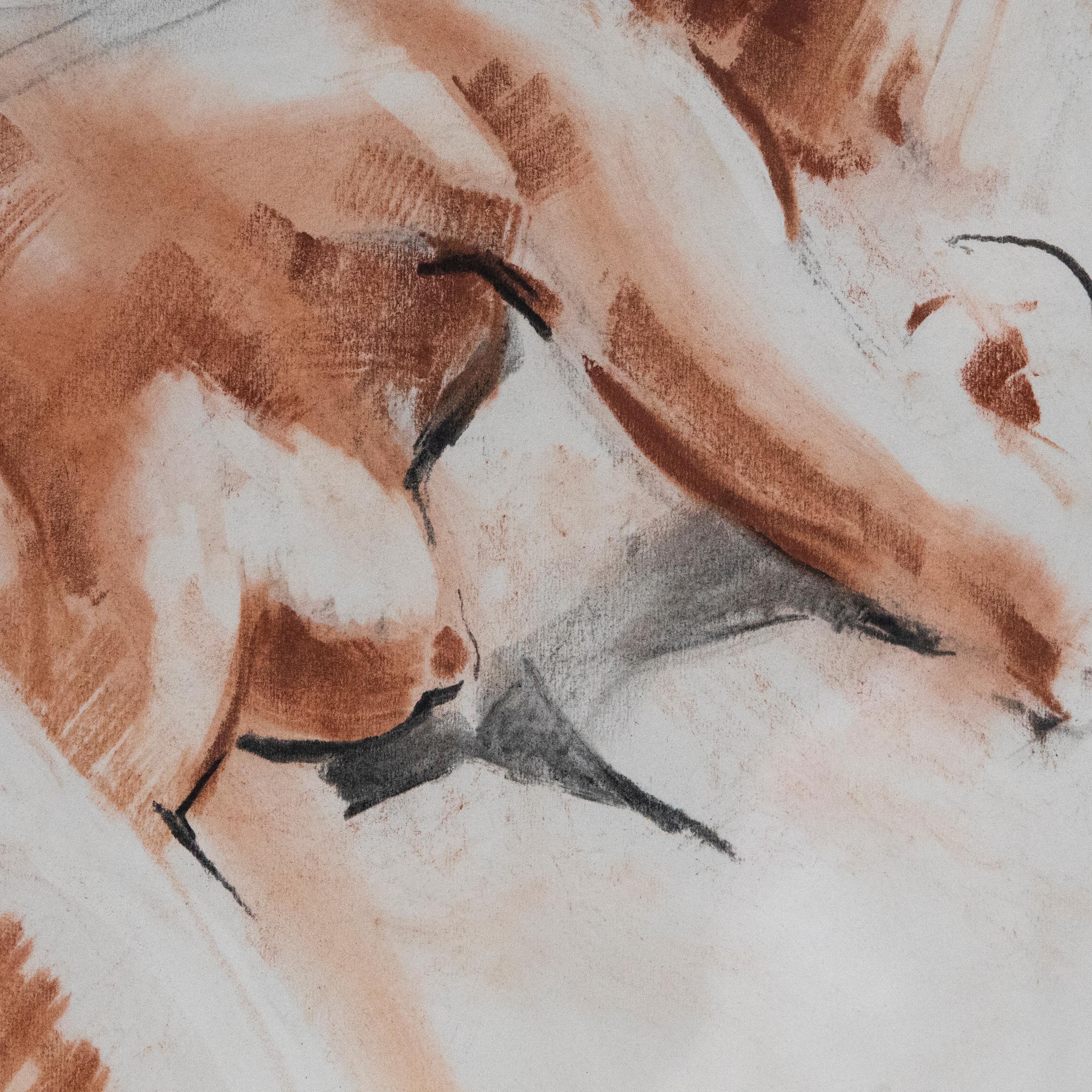 A charming study of a reclining nude model in expressive sanguine and charcoal markings. Signed to the lower right. Presented in a gilt frame. On paper.