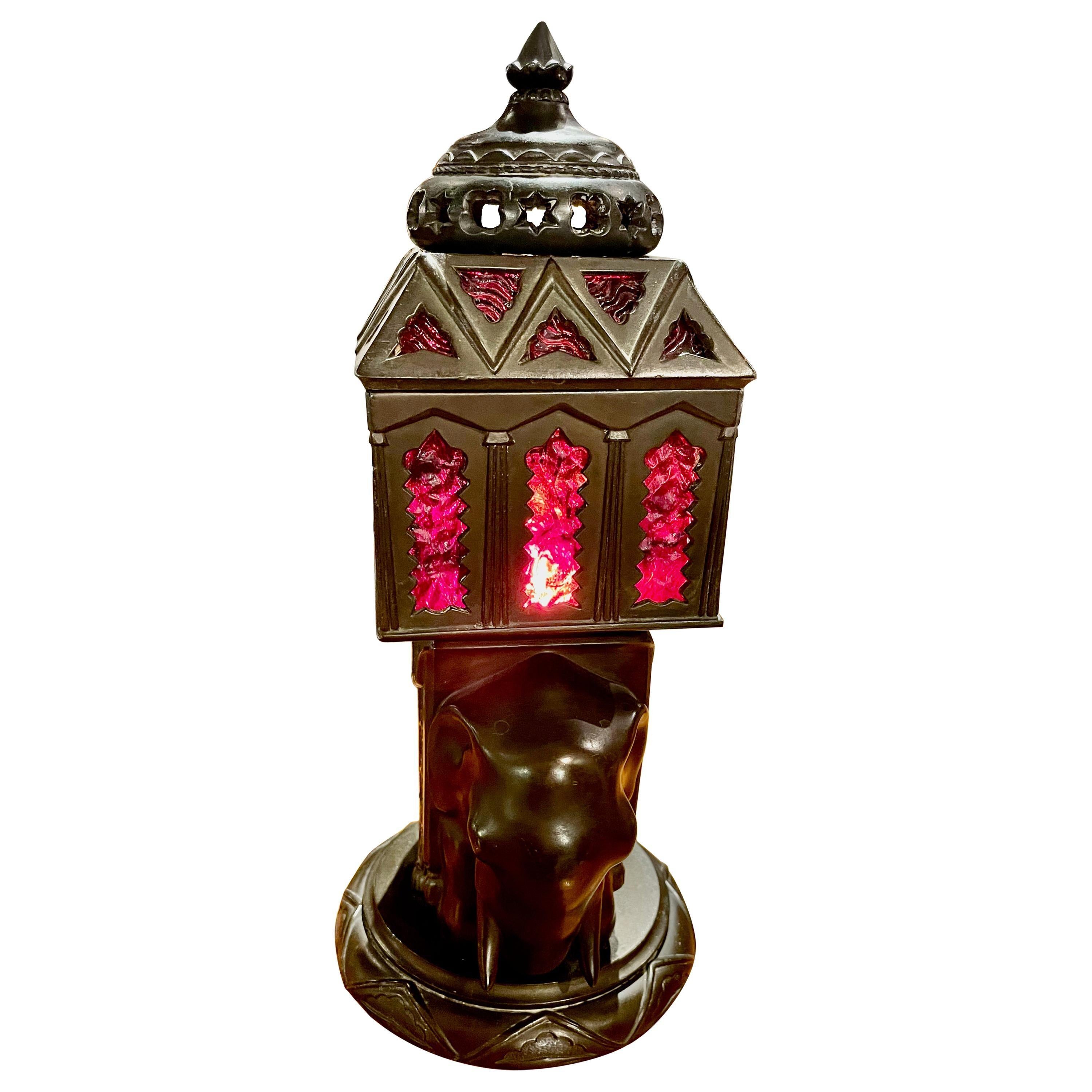 Art Deco elephant sculpture lamp French 1930, patinated art metal with antique red glass inlay. Excellent condition mood lamp with detailed embossed metal patterns of mosaic designs representing both Indian and Middle Eastern motifs. This is evident