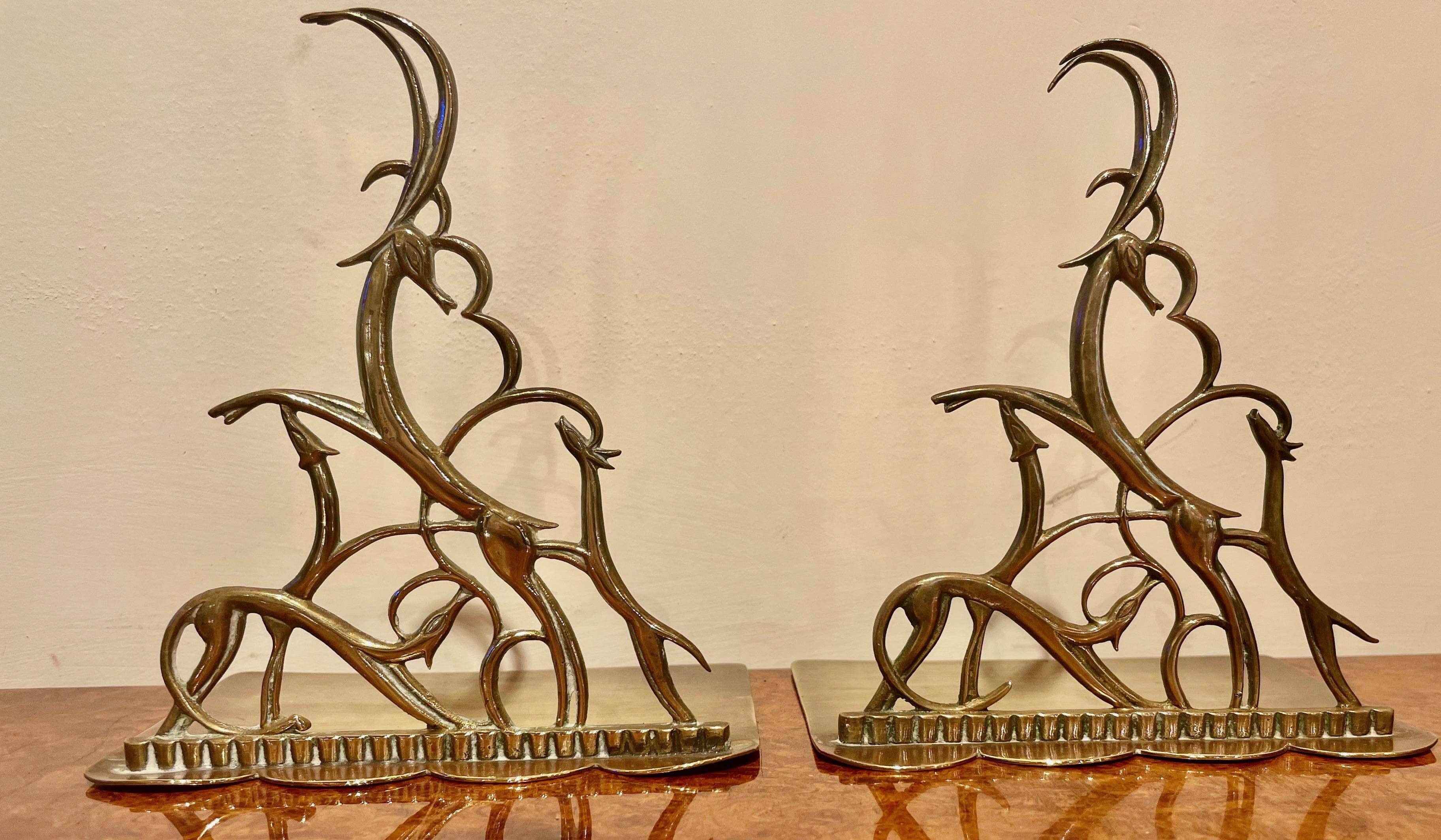 Hagenauer bookends pair leaping gazelles. The original had rubbed brass patina finish—stylized Haenauer animals, four intertwined and perfectly proportioned. The size is enough to support books and still look sculptural and elegant. Both items are
