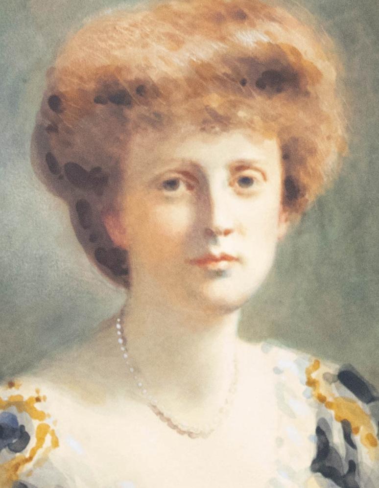 A fine oval portrait of an Victorian lady wearing a black and gold gown with red hair and pearls. The artist has portrayed the sitter with delicacy, highlighting the women's porcelain complexion and pinned back hair. The portrait has been left