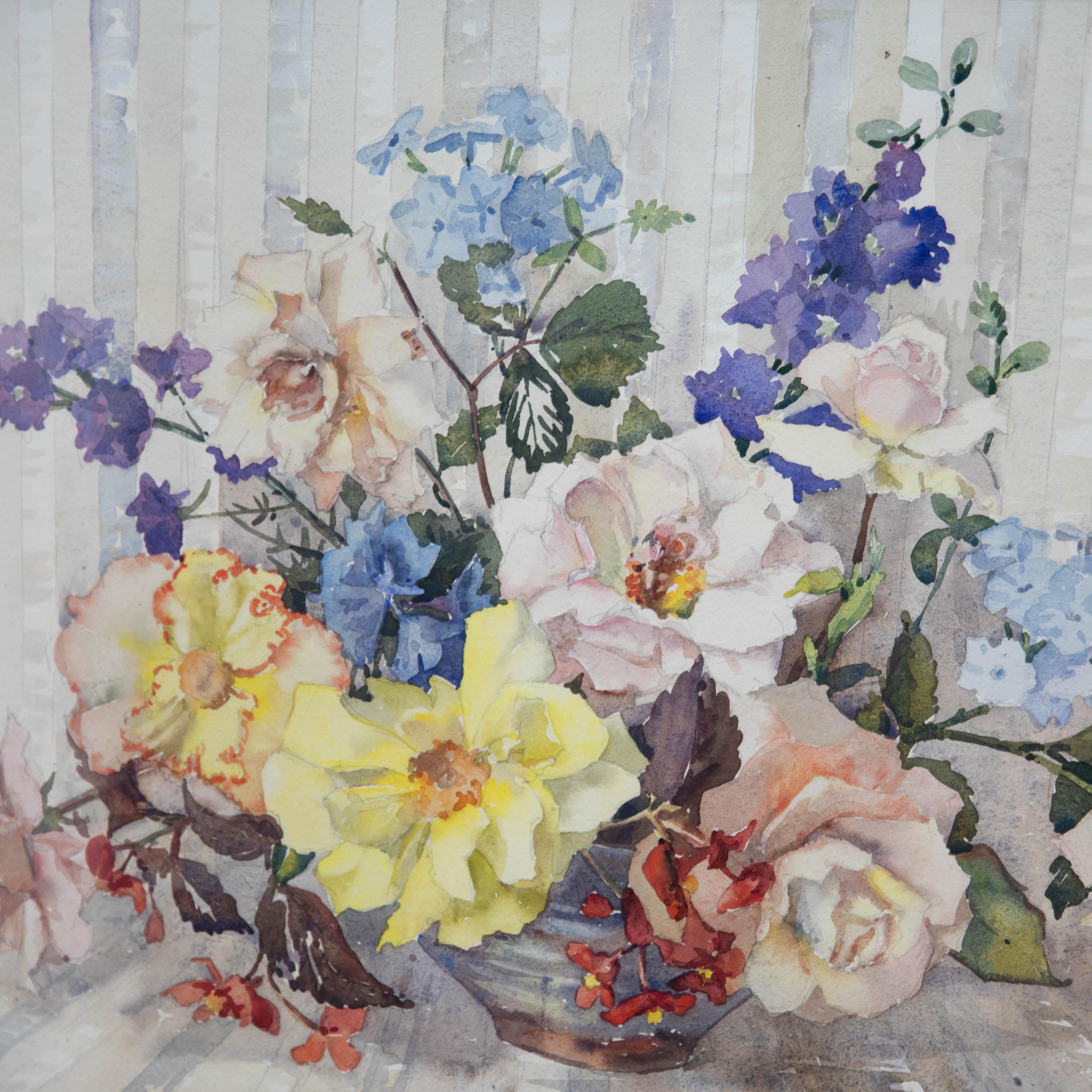 A bold botanical study by Phyllis I. Hibbert (1903-1971), showing an array of peonies, roses and delphiniums arranged in a shallow vase. The artist has signed to the lower right and the painting has been presented in a substantial wood frame. On
